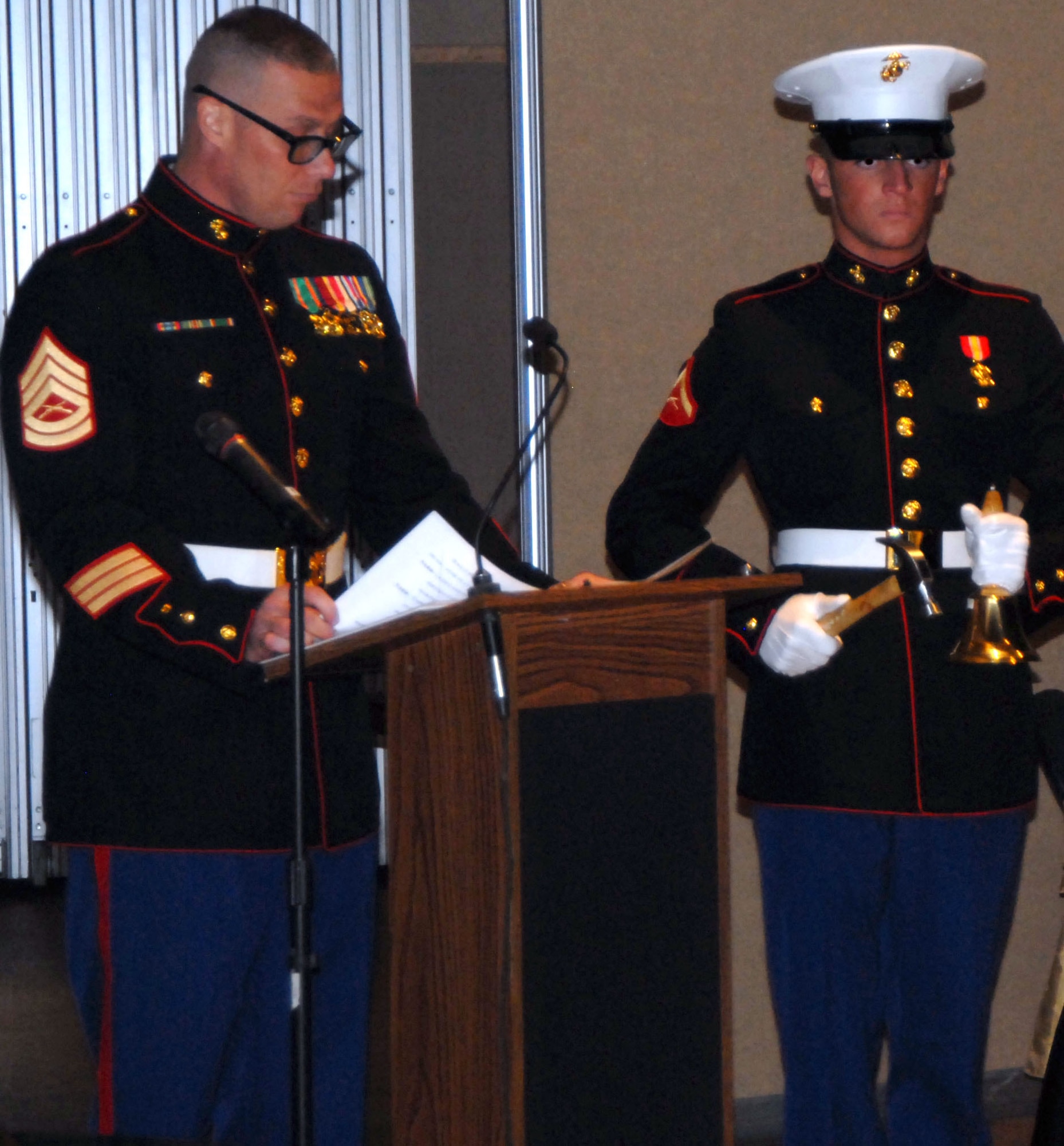 SAN ANGELO, Texas -- Marine Gunnery Sgt. Jeremy Walsworth reads the names of places where Marines have fought while Marine Lance Cpl. Seamus Dempsey sounds the bell after each location listed during the Marine Corps 235th Birthday Ball Nov. 12 at the McNease Convention Center. (U.S. Air Force photo/Airman 1st Class Jessica D. Keith)