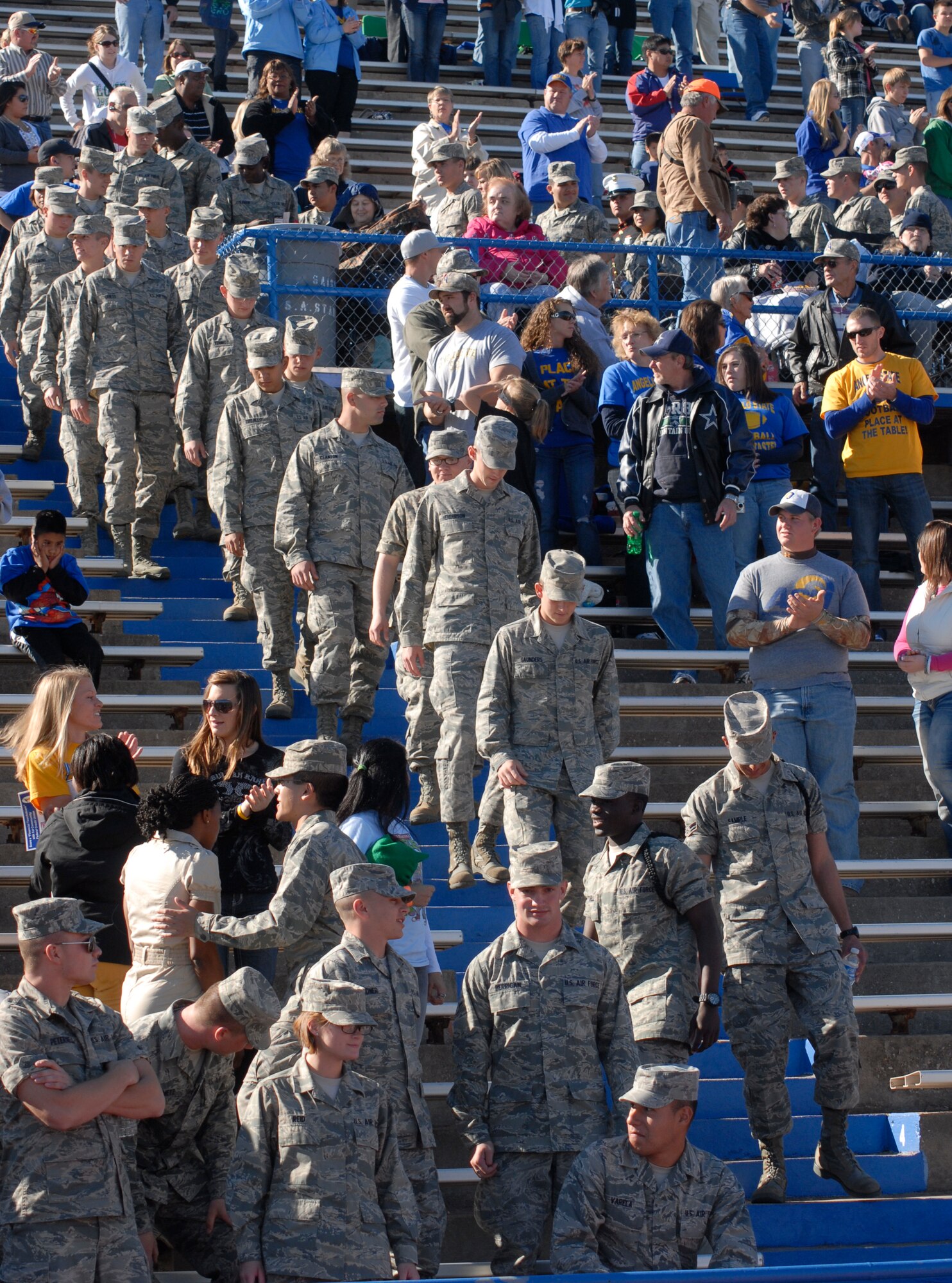 Airmen from the 17th Training Wing take their seats as Angelo State fans give them a standing ovation before the start of the Angelo State vs. Central Oklahoma football game Nov. 13.  Angelo State University and local groups sponsored several events to show their appreciation to all active duty and retired military personnel and their families. (U.S. Air Force photo/Master Sgt. Randy Mallard)
