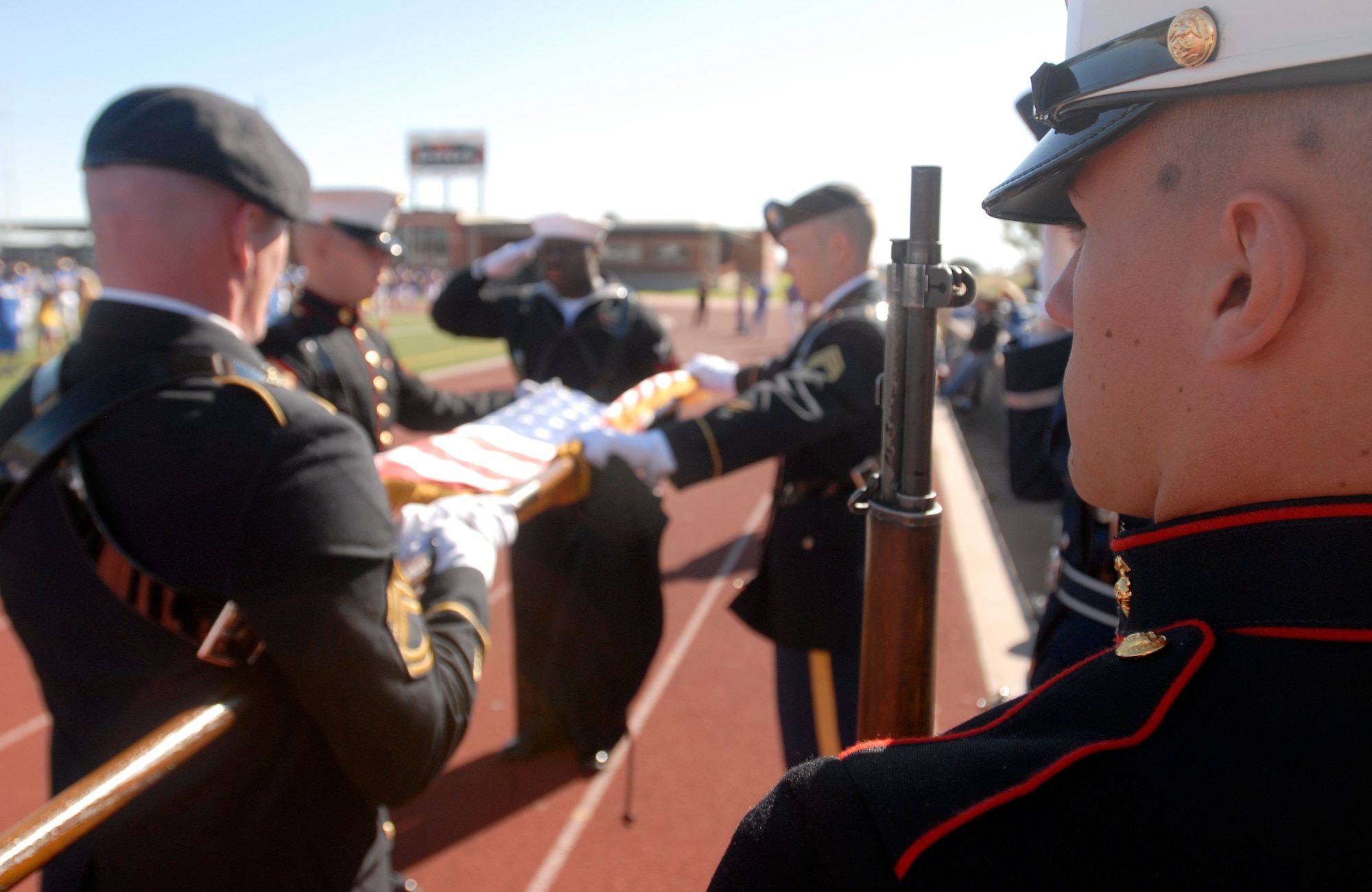 Members of the Goodfellow Joint Service Color Guard case the Colors after the start of the Angelo State vs. Central Oklahoma football game Nov. 13.  Angelo State University and local groups sponsored several events to show their appreciation to all active duty and retired military personnel and their families. (U.S. Air Force photo/Master Sgt. Randy Mallard)