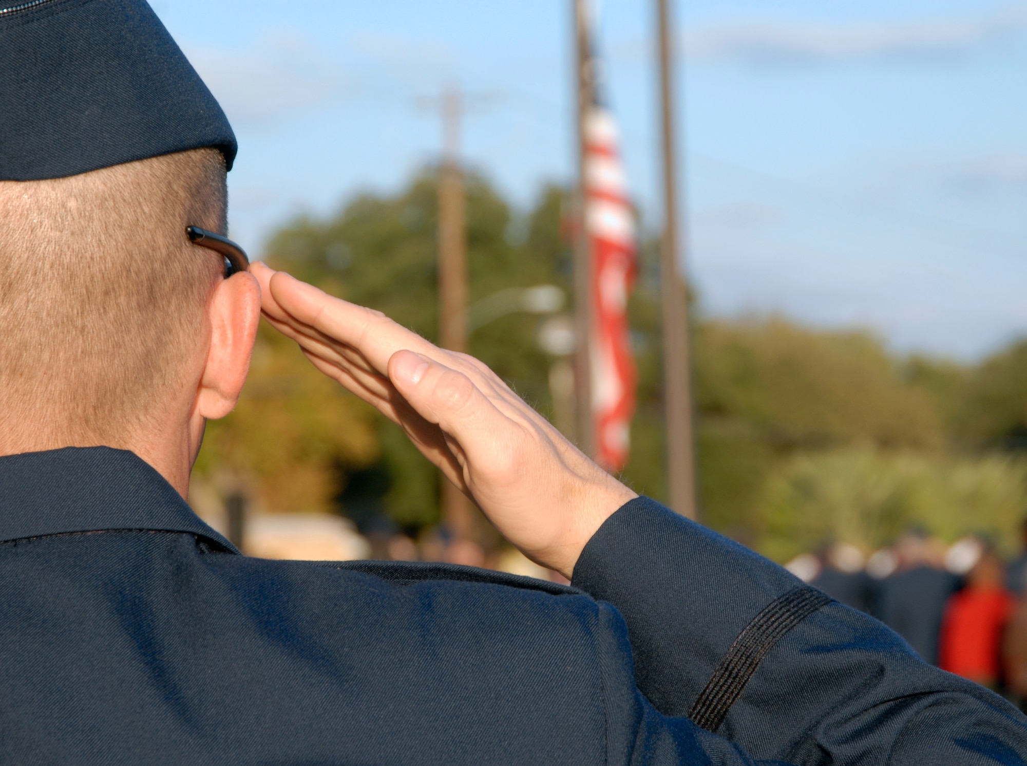 An U.S. Air Force officer renders a salute as the Colors are lowered during a retreat ceremony conducted by the Air Force Reserve Officer Training Corps Detachment 847 Angelo State University, San Angelo, Texas Nov. 10.  The retreat ceremony was followed by a vigil honoring the alumni who gave their lives during World War II. (U.S. Air Force photo/Master Sgt. Randy Mallard)
