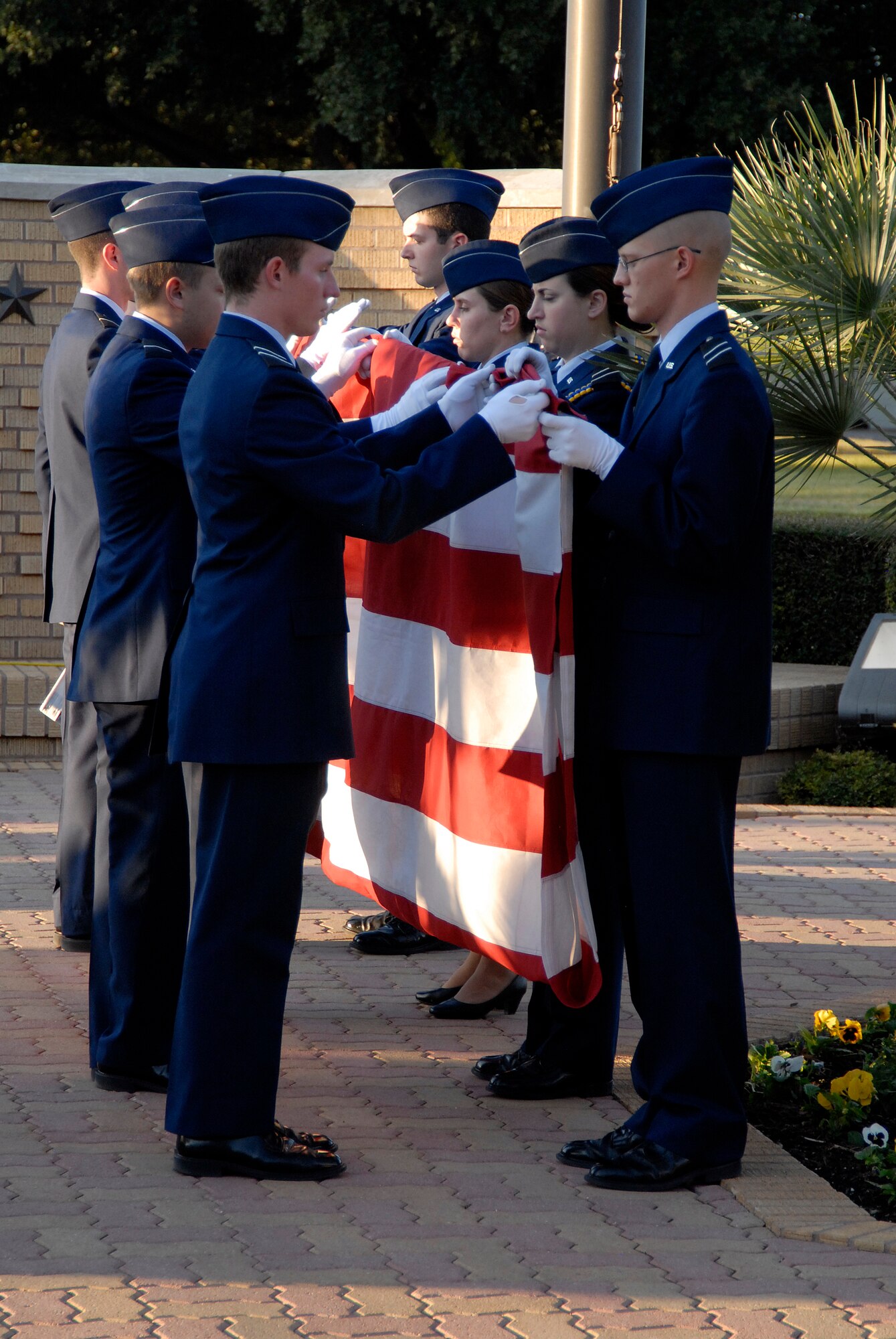 Cadets from the Air Force Reserve Officer Training Corps Detachment 847 Angelo State University, San Angelo, Texas fold the Colors during a retreat ceremony Nov. 10.  The retreat ceremony was followed by a vigil honoring the alumni who gave their lives during World War II.  (U.S. Air Force photo/Master Sgt. Randy Mallard)