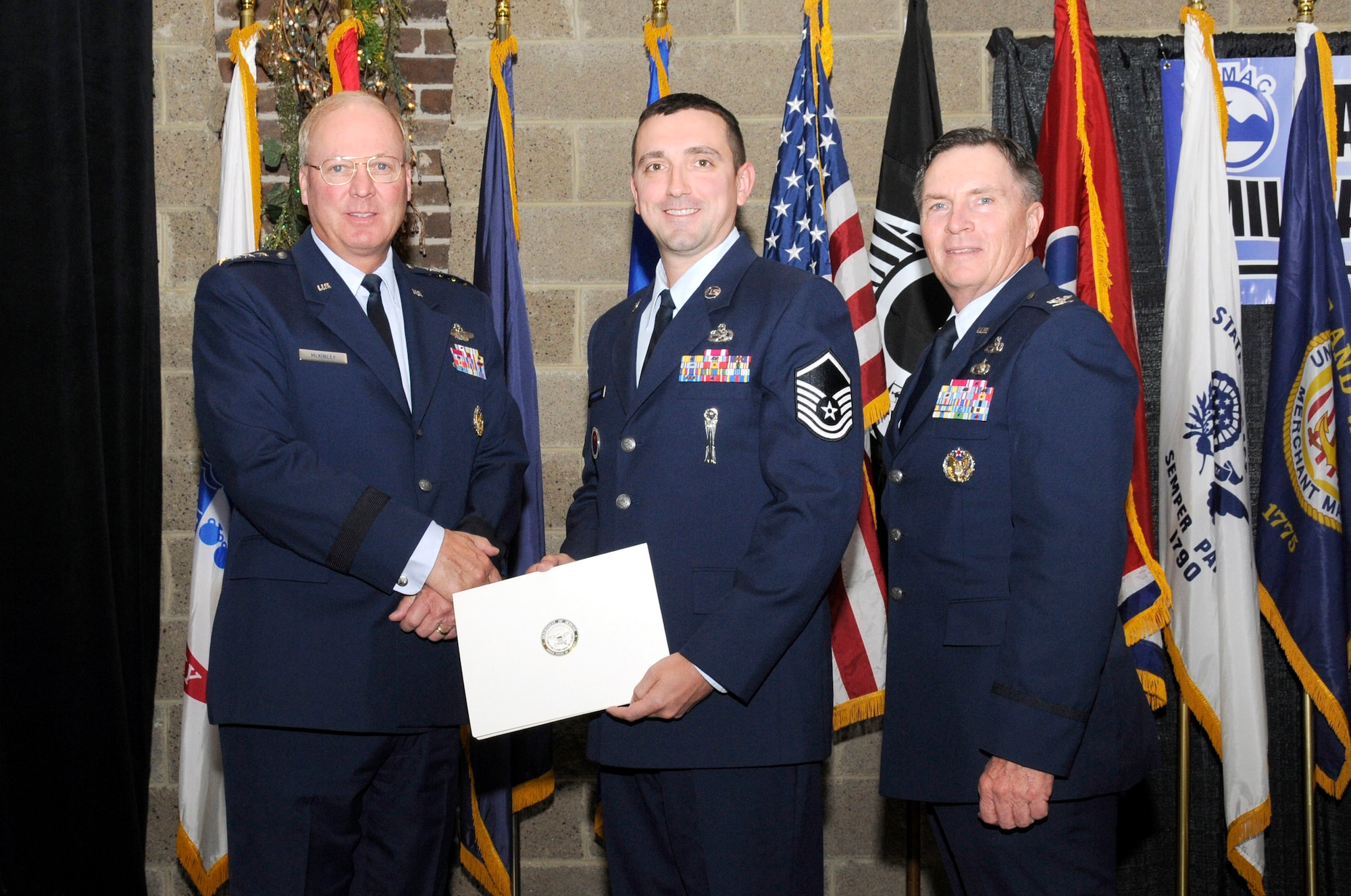 KNOXVILLE, Tenn. - Master Sgt. Keith M. Cavanaugh, center, a senior instructor at the Paul H. Lankford Professional Military Education Center at McGhee Tyson ANGB, is recognized by the East Tennessee Military Affairs Council for outstanding service during the 28th Annual Veteran's Day Awards and Recognition luncheon at the Foundry on the World's Fair site here, Nov. 11, 2010.  Also pictured are (L) Gen. Craig R. McKinley, Chief, National Guard Bureau, and (R) Col. Richard B. Howard, commander of The I.G. Brown Air National Training and Education Center.  (U.S. Air Force photo by Master Sgt. Kurt Skoglund/Released)