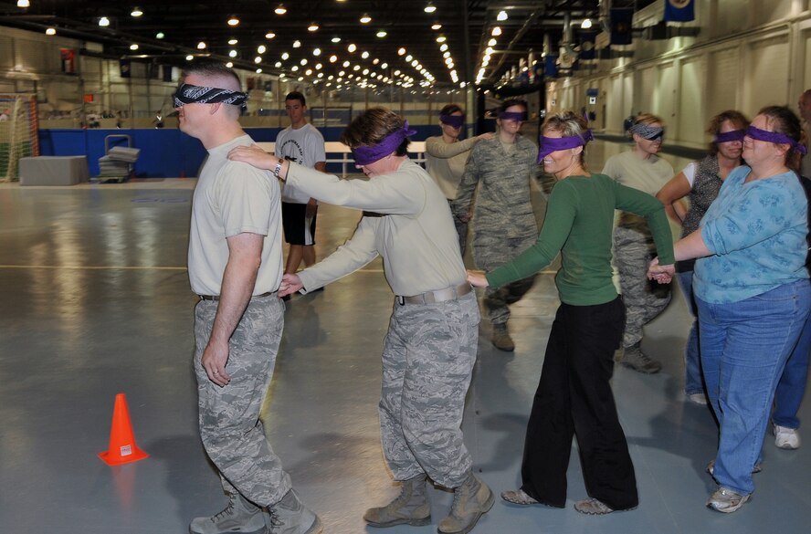 OFFUTT AIR FORCE BASE, Neb. - Members of the 55th Medical Group take part in the blind maze Nov. 12 during Wingman Day 2010. Airmen in the 55th Wing took part in various events and briefings during the day to promote teamwork and educate Airmen on topics such as suicide prevention and the dangers of drinking and driving. U.S. Air Force photo by Jeff W. Gates. 
