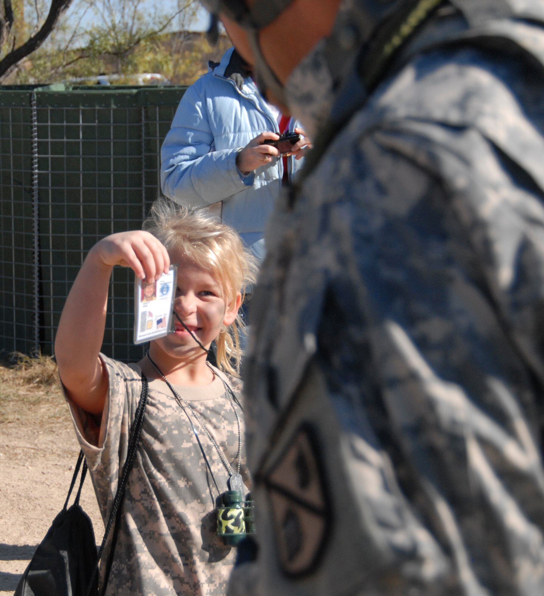 GODFELLOW AIR FORCE BASE, Texas -- Anna Abbott, 7, shows her ID card before entering Camp Discovery during Operation KIDS Nov. 13.  More than 60 military youths participated in this year's event to get a glimpse of what their military parent(s) go through when deploying.  (U.S. Air Force/Connie Hempel)