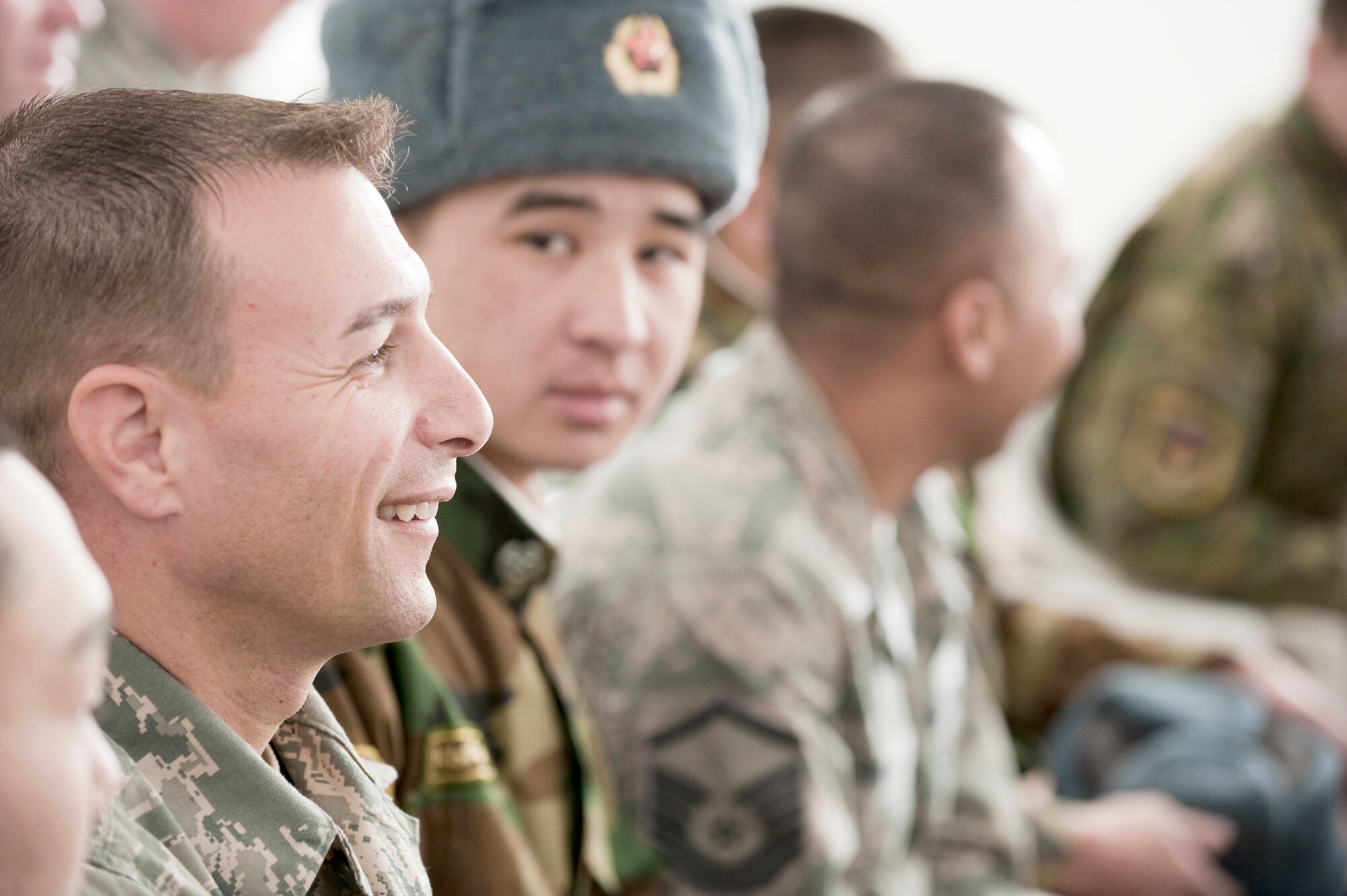 Master Sgt. John Lamp sits with other U.S. and Kyrgyz servicemembers during a cultural concert by students at the Chuiskaya Region Boarding School-Gymnasium Nov. 11, 2010, in Koi Tash, Kyrgyzstan. The two militaries gave students coats, blankets and hats as part of Operation Warm and Dry II. Sergeant Lamp is a first sergeant at the Transit Center at Manas. (U.S. Air Force photo/Tech. Sgt. Jennifer Buzanowski)