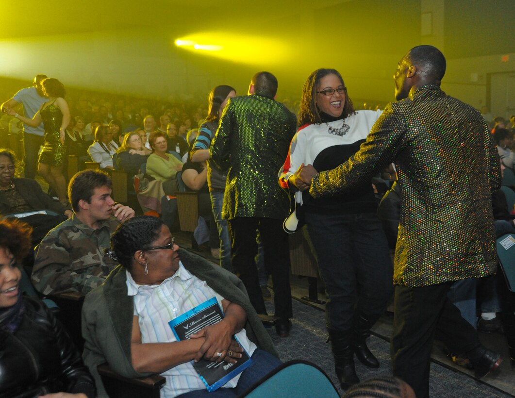 Tracey Wright, a former Tops in Blue performer, dances with TIB member, Senior Airman Adam Rideaux, 341st Medical Group, Malmstrom Air Force Base, Mont., during a crowd interaction routine inside the Reel Time Base Theater at Andrews Nov. 13. The TIB troupe performed Nov. 13 and 14. (U.S. Air Force photo/Bobby Jones)