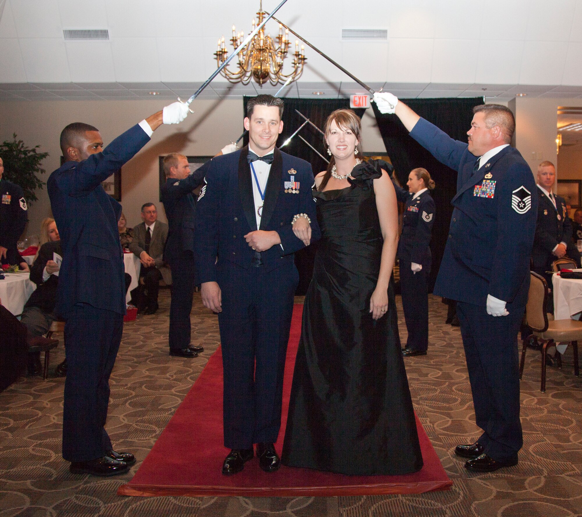 Master Sgt. Bradley Orr and his wife, Roxie, walk through the Saber Arch Nov. 6, 2010, during an Arkansas Air National Guard Senior NCO induction ceremony at Little Rock Air Force Base, Ark. Fifteen inductees walked through the saber arch into the senior ranks of the Air Force. (U.S. Air Force photo by Master Sgt. Dianna Seerey)