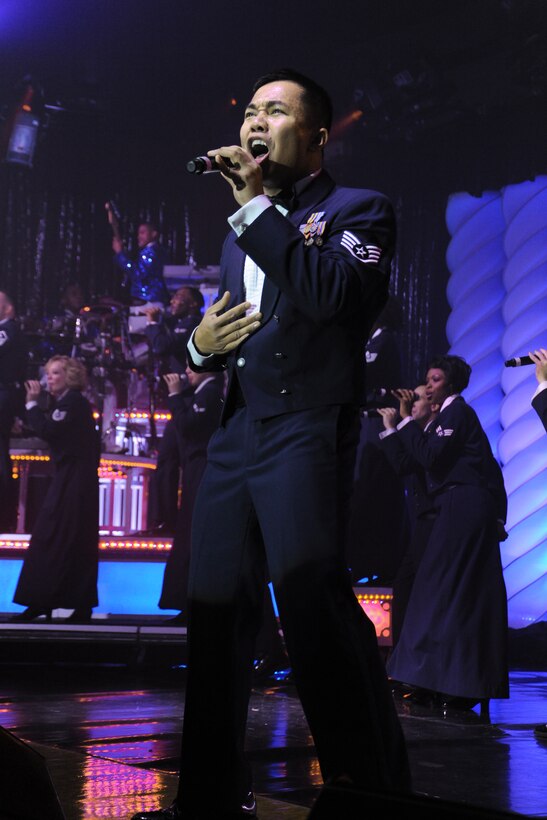 Staff Sgt. Harron Elloso, 633rd Force Support Squadron, Langley Air Force Base, Va., belts out the Tops in Blue signature closing song, “God Bless the USA,” by country musician, Lee Greenwood, inside the Reel Time Base Theater at Andrews Nov. 13. The TIB troupe performed Nov. 13 and 14. (U.S. Air Force photo/Bobby Jones)