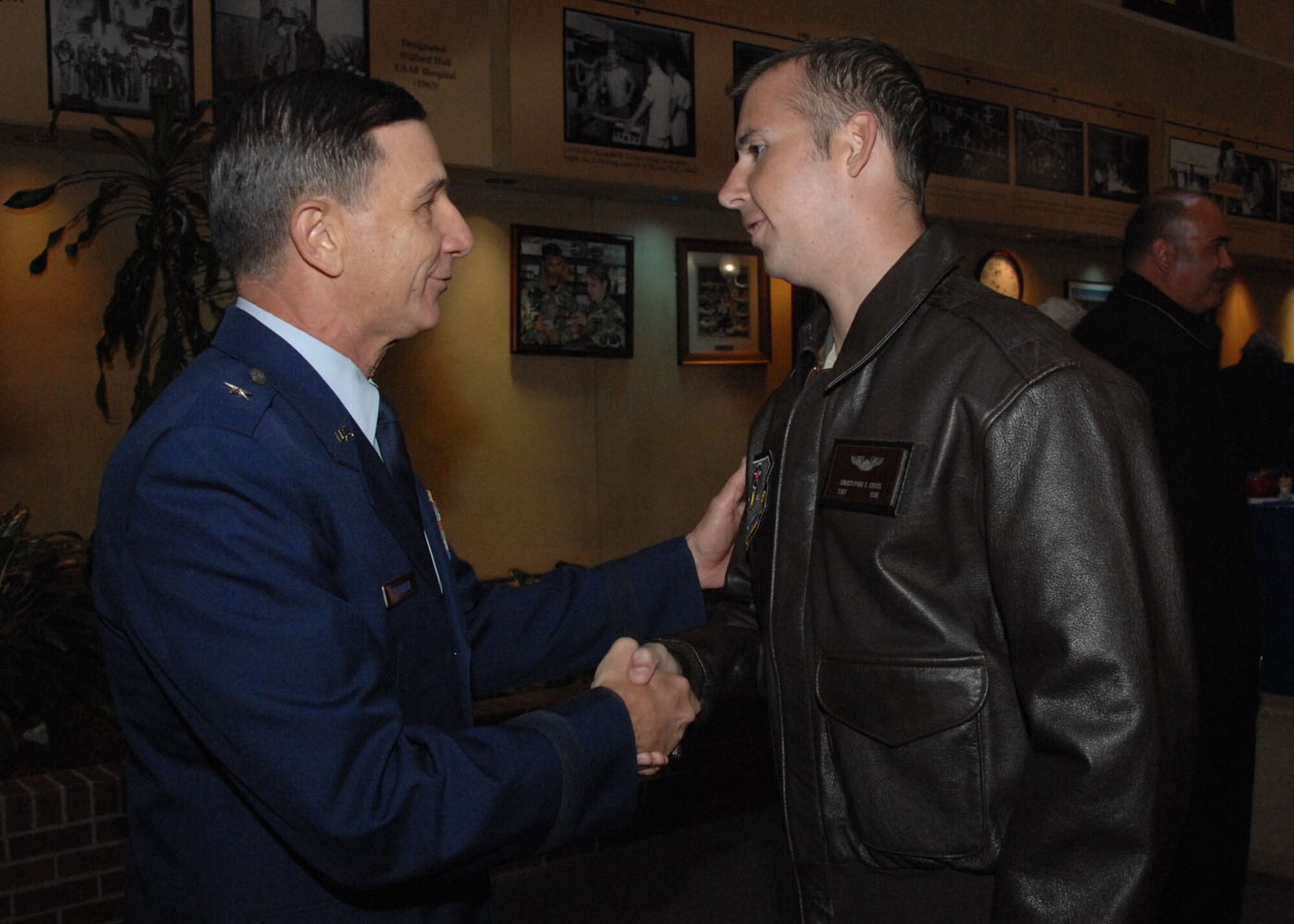 Brig. Gen. Byron Hepburn, new 59th Medical Wing Commander (left), greets U.S. Air Force Staff Sgt. Chris Curtis (right) after the wing's change of command ceremony at Wilford Hall Medical Center, San Antonio, Texas Nov. 16, 2010. Sergeant Curtis, who became a wounded warrior when his helicopter crashed in Afghanistan April 9, was treated at Walter Reed Army Medical Center where General Hepburn visited him during his recovery. Sergeant Curtis is now being treated at the Center for the Intrepid at Fort Sam Houston, San Antonio, Texas.  (U.S. Air Force photo by Staff Sgt. Robert Barnett/Released)