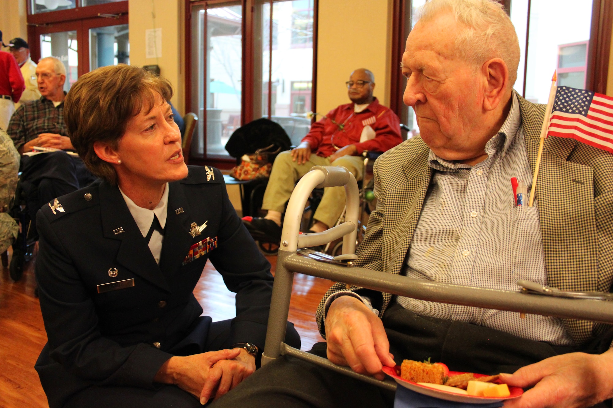 310th Wing Commander Col. Karen Rizzuti speaks with ex-POW Ned Nichols following a Veterans Day ceremony at the veteran's nursing home in Aurora, Colo.The 310th SW teamed up with the Denver Hospice to honor local veterans at the Veterans Nursing Home at Fitzsimons on Nov. 11. (U.S. Air Force photo/Tech. Sgt. Scott P. Farley)