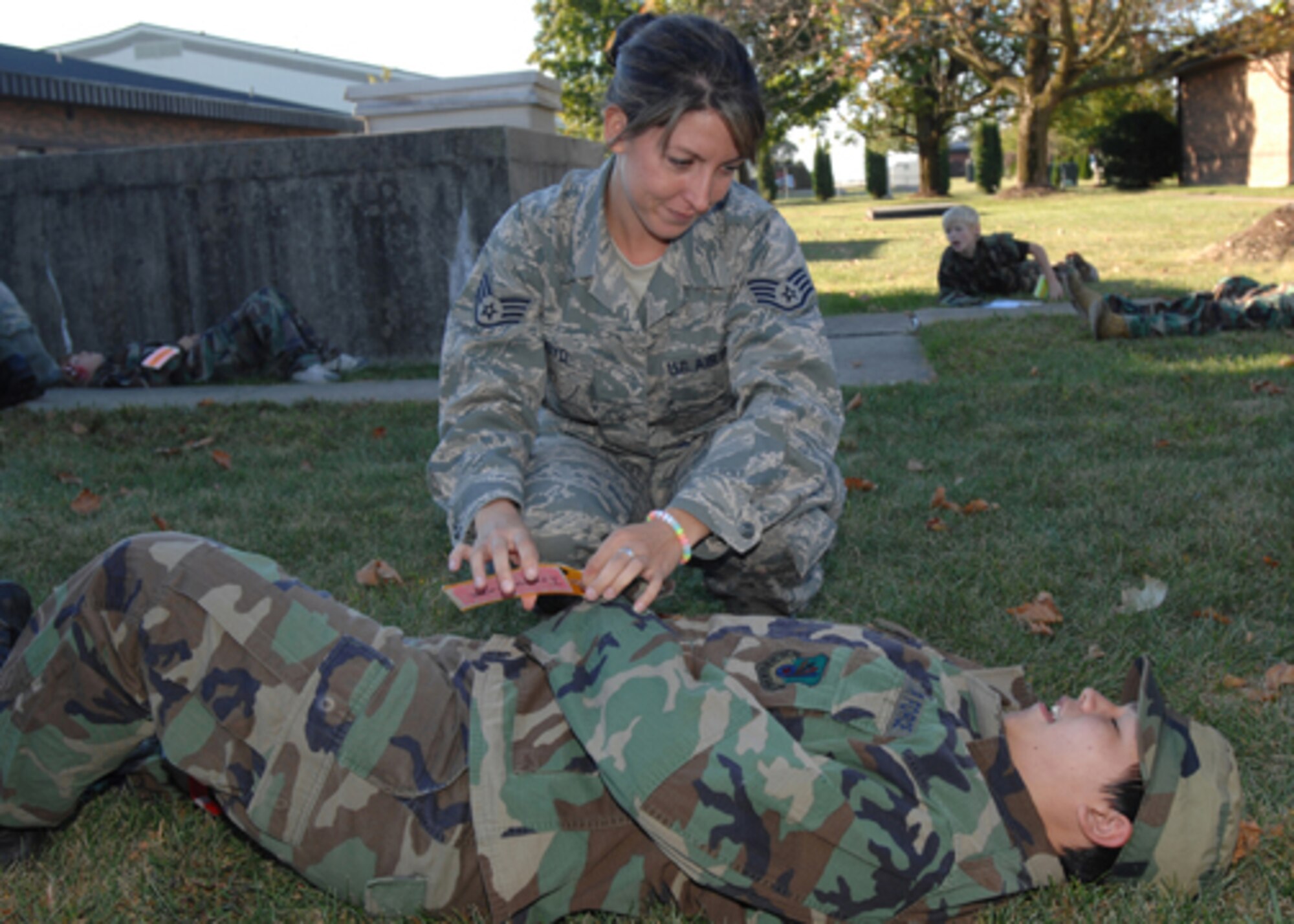 GRISSOM AIR RESERVE BASE, Ind., -- The 434th Aerospace Medicine Squadron held a mass casualty exercise during a unit training assembly. The goal of the training was to provide the medical members an opportunity to practice their initial assessment skills, radio communication skills, self-aid buddy care and teamwork. Here Staff Sgt. Joanna Boyd, 434th AMDS medical technician, gives initial treatment to a simulated casualty. The actors were from Boy Scout Troop 229 from Winamac, Ind. (U.S. Air Force photo/Senior Airman Carl Berry).