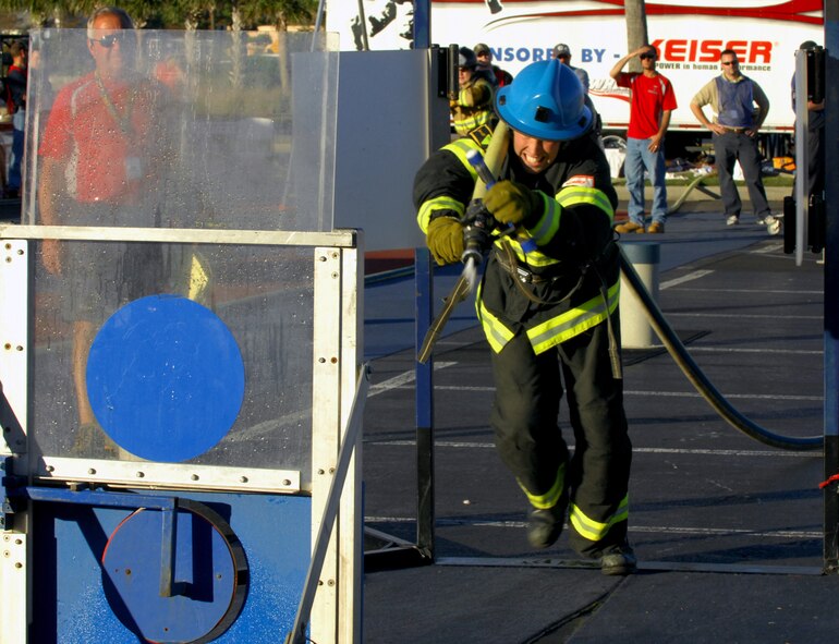MYRTLE BEACH, S.C. -- Staff Sgt. Steven Thomas, 20th Civil Engineer Squadron firefighter, bursts through the doors and sprays the target during the World Scott Firefighter Combat Challenge Nov. 13th. The competition is considered "the toughest two minutes in sports" and seeks to encourage firefighters' fitness, as well as demonstrates the challenges of the profession to the public. Shaw firefighters placed 16th among 175 different teams from across the U.S., as well as from France, Germany, Slovenia, Canada and New Zealand at the competition. (U.S. Air Force photo/Airman 1st Class Daniel Phelps (Released))