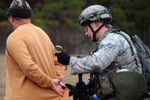 Senior Airman Sean Phelan, 2nd Security Forces Squadron, from Barksdale Air Force Base, La.,  detains a scenario role player during the tactics portion of the Global Strike Challenge at Camp Minden, La., Nov. 13. More than 400 participants took part in GSC competitions at various locations on base. Teams have the opportunity to display their innovative thinking, teamwork and esprit de corps . (U.S. Air Force photo/Senior Airman Brittany Y. Bateman)