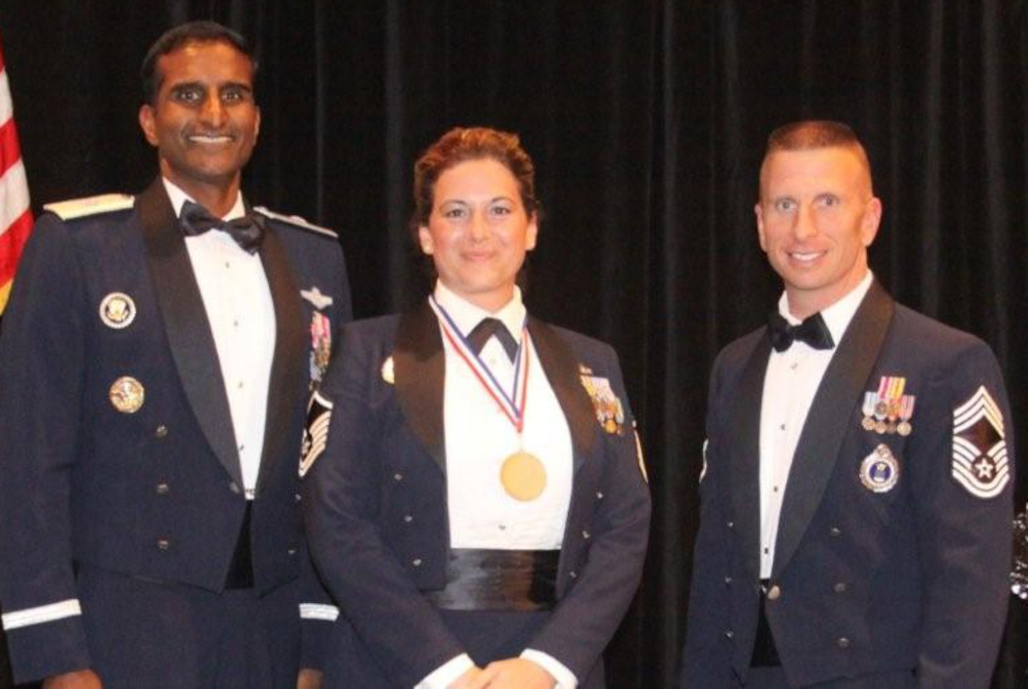 Master Sgt. Catherine LeGrand, an enlisted accessions recruiter from Clarksville, Tenn., wears her gold medal awarded by Brig. Gen. Balan R. Ayyar, commander of Air Force Recruiting Service. Sergeant LeGrand received the award at the 332nd Recruiting Squadron’s annual awards banquet Oct. 25. At right is Chief Master Sgt. George Skender, superintendent of AFRS IG. (U.S. Air Force photo)