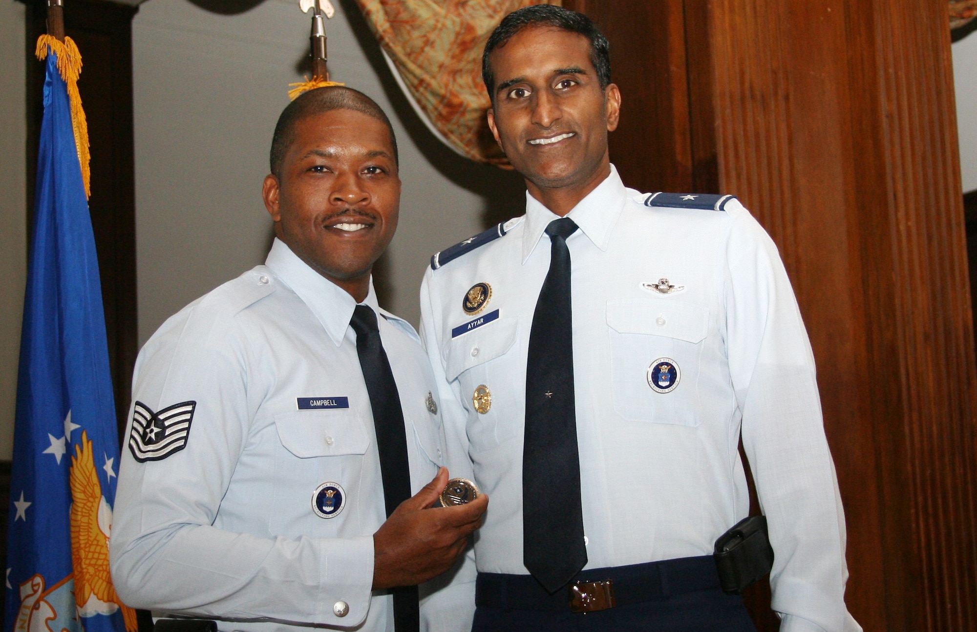 Tech. Sgt. Walter Campbell of the 314th Recruiting Squadron displays his commander’s coin from Brig. Gen. Balan R. Ayyar, commander of Air Force Recruiting Service. Sergeant Campbell was coined during the state of the command briefing for his question regarding diversity. The general also praised Sergeant Campbell, a professional comic, after his stand-up routine during the annual awards activities for the squadron in October. (U.S. Air Force photo)