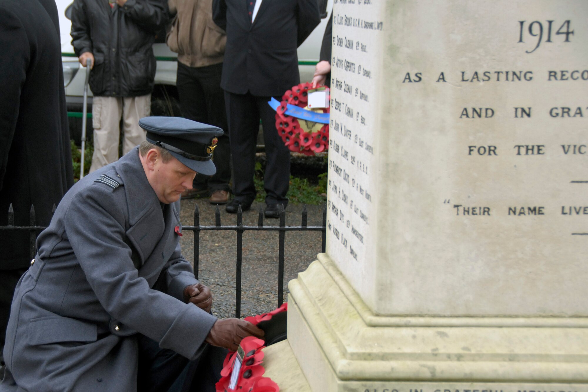 LAKENHEATH, England – Squadron Leader Jeremy Neild, RAF Lakenheath commander, places a wreath of red poppies on the Lakenheath War Memorial during a Remembrance Sunday ceremony Nov. 14.  In the U.K., wearing red poppies and laying poppy wreaths at memorial sites is a way to remember those who lost their lives or were injured during war. (U.S. Air Force photo/Airman 1st Class Erin Zabarnick) 