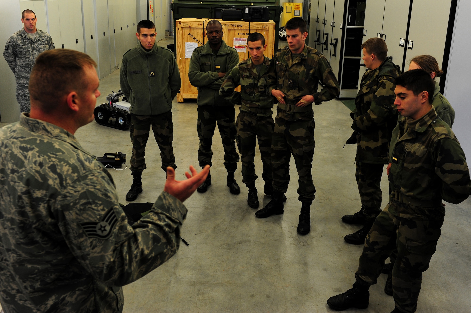 U.S. Air Force Staff Sgt. Kristopher Parker, 886th Civil Engineer Squadron, briefs French air force cadets on the various robots used as a Explosive Ordnance Disposal technician, Ramstein Air Base, Germany, Nov. 16, 2010. The cadets will be visiting several locations on base during the tour.(U.S. Air Force photo by Airman 1st Class Brea Miller)