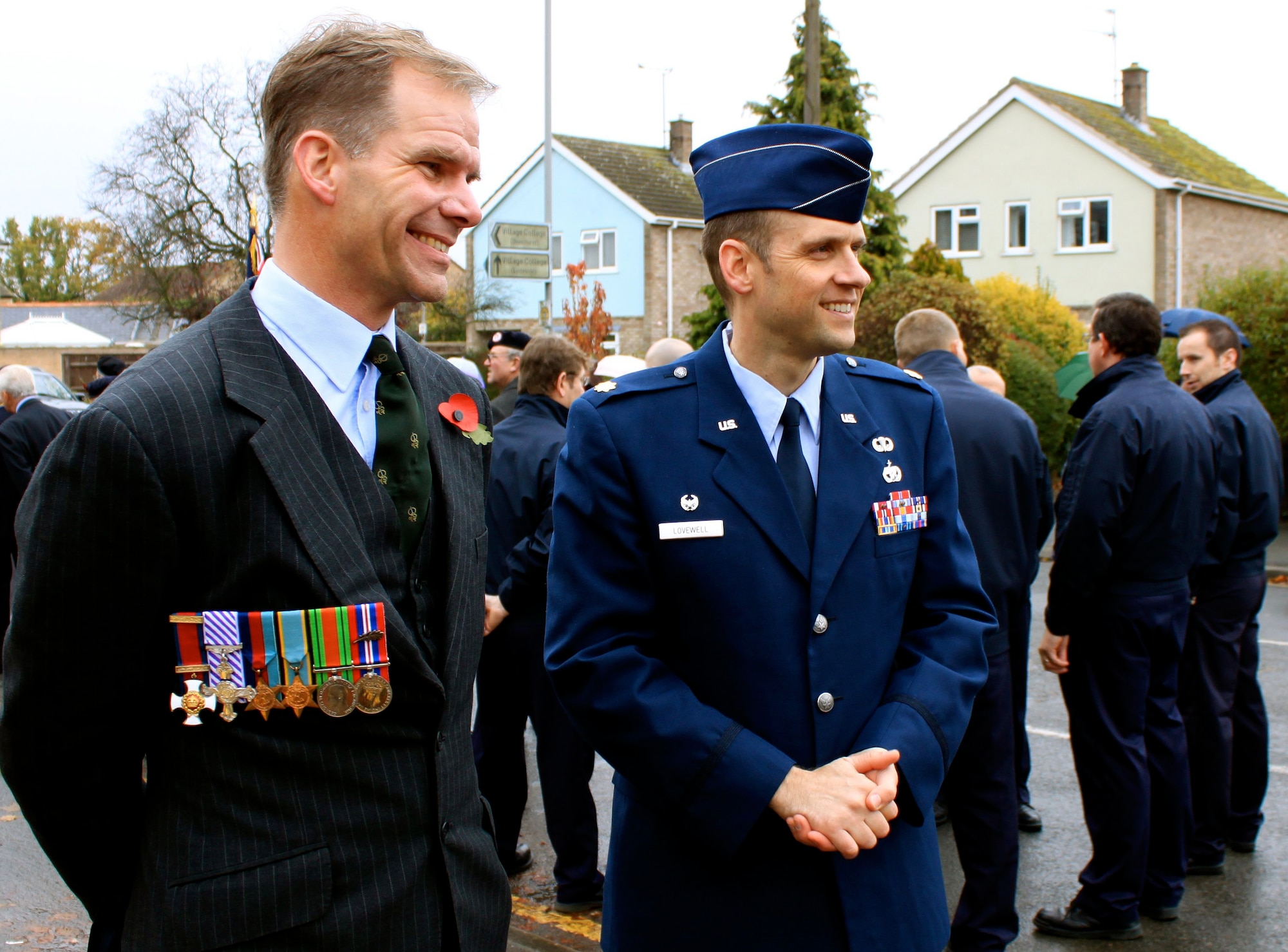 SOHAM, England -- Hamish Ross, 100th Logistics Readiness Squadron honorary commander, and Maj. James Lovewell, 100th LRS commander, await the start of the Remembrance Sunday Parade in nearby Soham Nov. 14. The 100th LRS provided a marching detail for the parade. Mr. Ross wore the medals of his uncle who served as a reconnaissance and bomber pilot during World War II. (Courtesy photo/Wendy Bell)