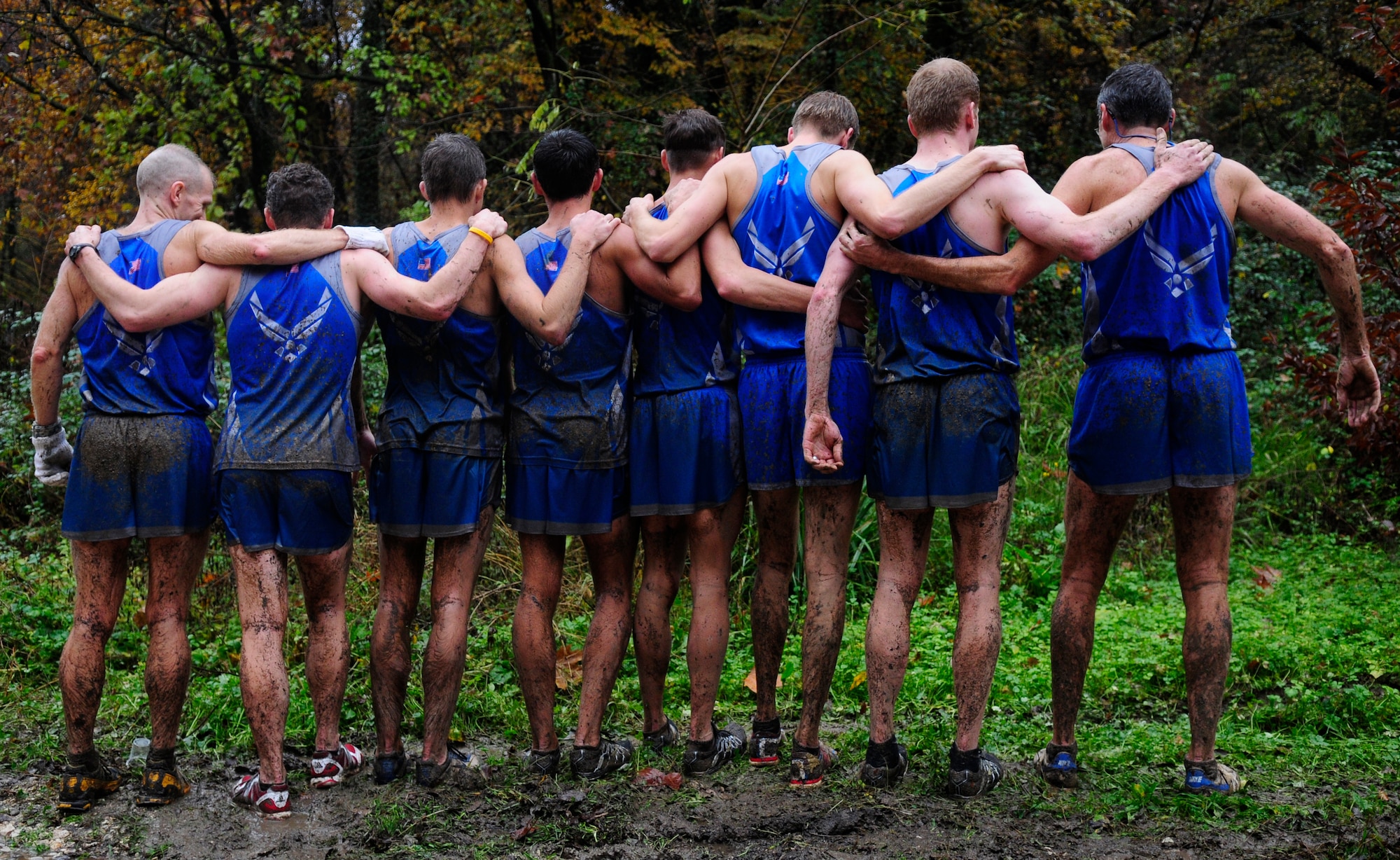 Members of the U.S. Air Force team pose for a photo showing their backs after running through muddy trails in the Allied Forces Cross Country Championships Nov. 9 in Budoia, Italy. Members from different European air forces, including England, Germany and Poland, competed in the championships. (U.S. Air Force photo by Airman 1st Class Katherine Windish)