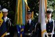 Airman 1st Class Bryan Hrinek bears the U.S. Air Force flag as part of a Joint Service Color Guard during the wreath dedication at The Tomb of the Unknowns, Nov. 11, 2010. To his left and right are servicemen representing all five military branches. Airman Hrinek is surrounded by flag streamers representing major battles and wars Airmen have participated in. (U.S. Air Force photo by Benjamin Newell)