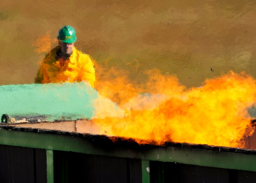 Matt O’Conner, Air Burners sales manager, watches the flames inside the 46th Test Wing’s new air curtain incinerator after another load of particle board was placed inside.  Mr. O’Conner maintained and adjusted the flow of air over the top of the burner to control the flames based on the wind and amount being burnt.  (U.S. Air Force photo/ Samuel King Jr.)