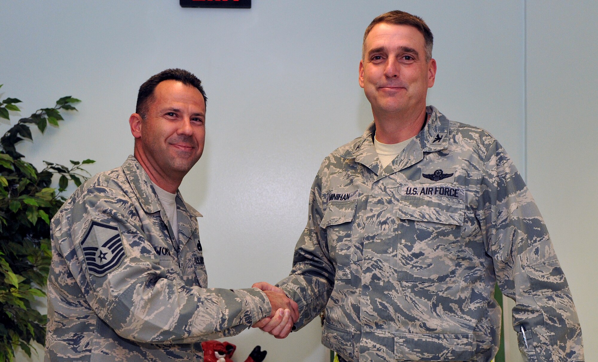 Col. Mike Minihan(right), the 19th Airlift Wing commander, presents a coin to Master Sgt. Kenneth Womack, a 96th Aerial Port Squadron special handling superintendent, Nov. 15, 2010, for his selection as the Combat Airlifter of the Week at Little Rock Air Force Base, Ark. Sergeant Womack led his squadron personnel to an “Excellent” rating during the Position the Force portion of the 96th APS 2010 Operation Readiness Inspection. (U.S. Air Force photo by Senior Airman Gul Crockett)