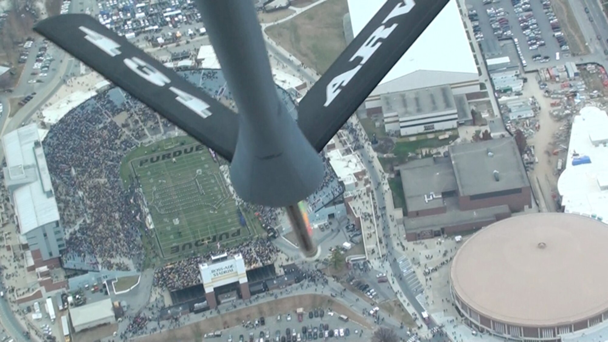 The boom of a KC-135R Stratotanker is visible from the boom operator's point of view as a tanker from the 434th Air Refueling Wing conducts a flyover of the football stadium at Purdue University, West Lafayette, Ind. The Pentagon-approved flyover was conducted as part of the opening ceremonies as Purdue hosted Michigan. (U.S. Air Force photo/Chief Master Sgt. Jeff Henry)
