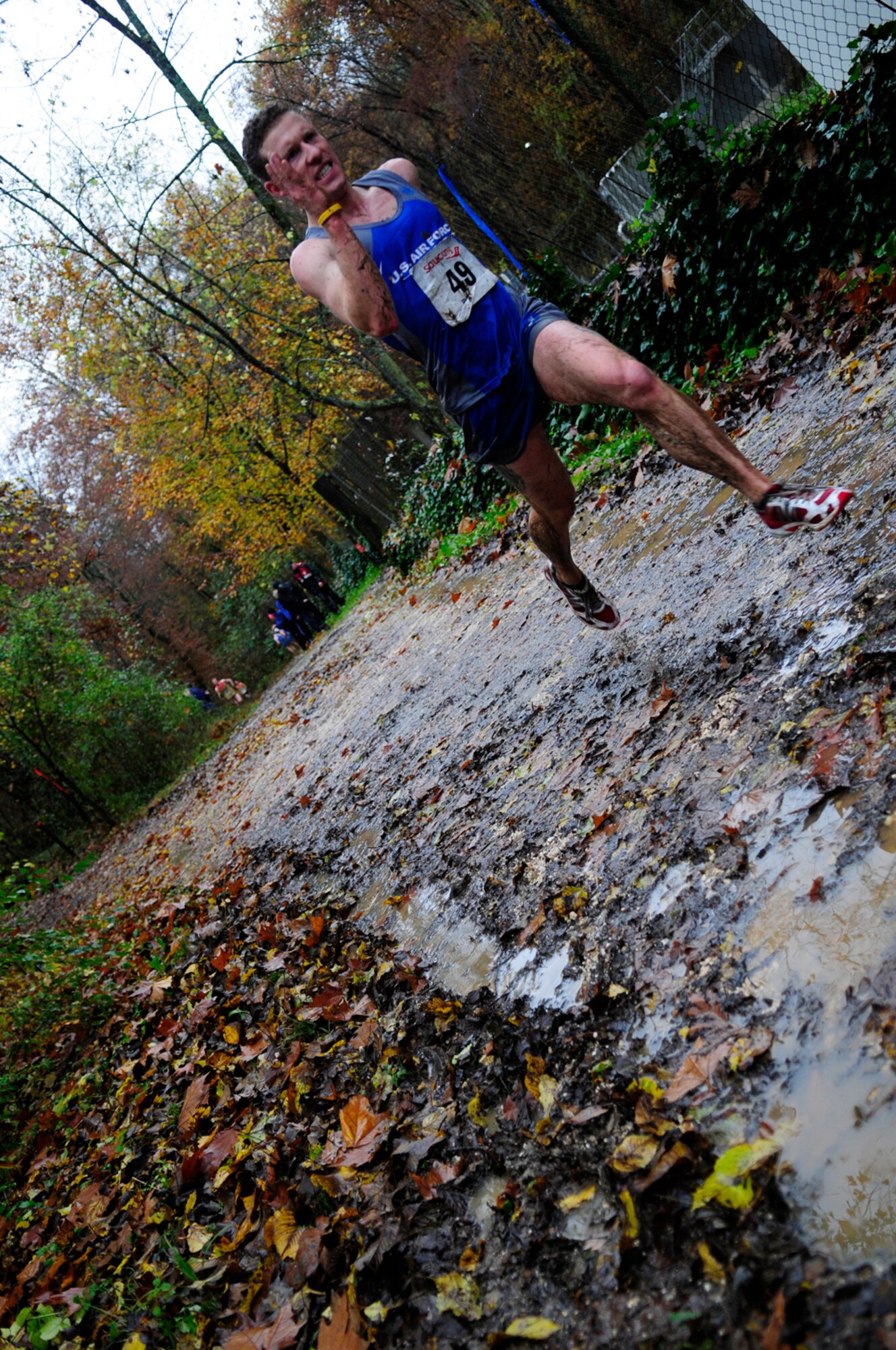 AVIANO AIR BASE, Italy -- Airman 1st Class Jon Porubsky, 100th Security Forces Squadron, runs along muddy trails during the Headquarters Allied Air Command Cross Country Championships Nov. 9, 2010, at Aviano Air Base, Italy. Airman Porubsky was part of the U.S. Air Forces in Europe men's cross country team, and competed against other teams from different European air forces, including those from England, Germany and Poland. The USAFE team placed second to the Polish air force team. The 100th SFS Airman described the course as very muddy and slippery, with sharp turns that went around cliffs that you could have fallen off and rolled down a mountain. (U.S. Air Force photo/Airman 1st Class Katherine Windish)