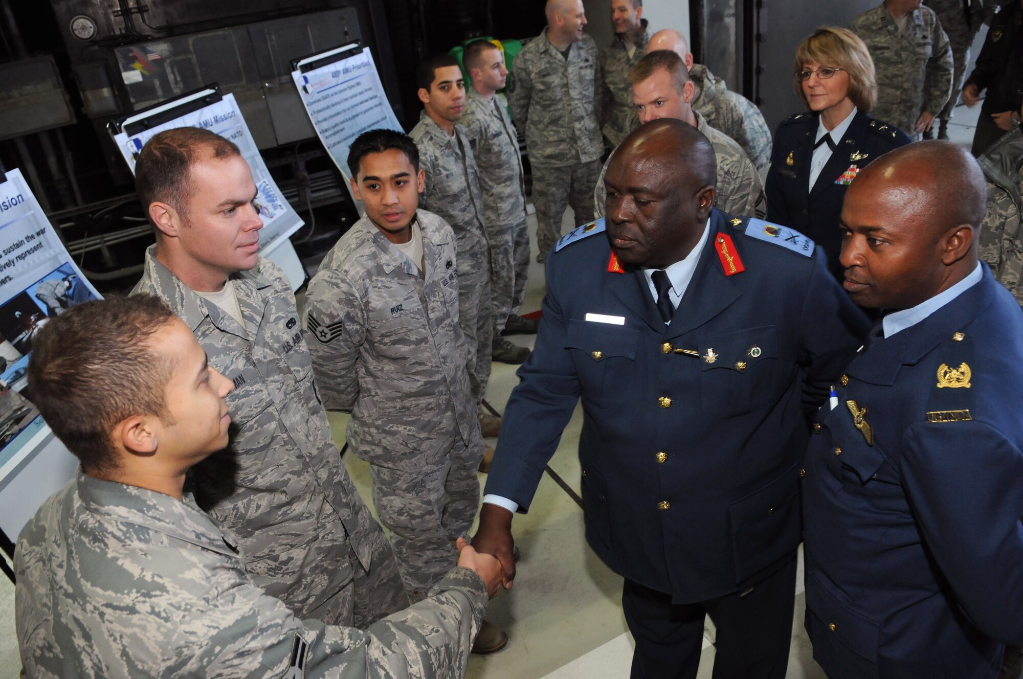 SPANGDAHLEM AIR BASE, Germany -- Maj. Gen. Jim Beesigye Owoyesigire, left, Ugandan Peoples Defense Air Force commander, shakes hands with Airman 1st Class Jeramy Frazier, 52nd Aircraft Maintenance Squadron weapons load crew member, during his visit Nov. 10. General Owoyesigire toured several squadrons on Spangdahlem Air Base to gain a greater understanding of how the U.S. Air Force operates. (U.S. Air Force photo/Staff Sgt. Benjamin Wilson)