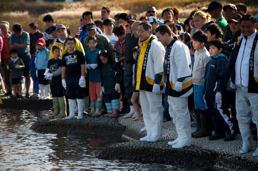 Eager fish catchers wait on the edge of the wading pool at Salmon Park, Oirase, Japan, at the start of the Oirase Salmon Catching Festival, Nov. 13, 2010. Participants were given the opportunity to catch their own salmon with their hands. (U.S. Air Force photo by Staff Sgt. Samuel Morse/Released)