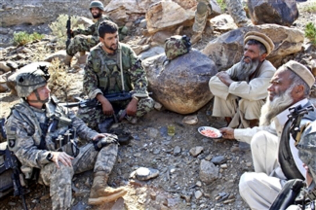 U.S. Army 2nd Lt. Daniel Wild (left) and an Afghan army weapons team leader (2nd from left) talk with Gurem village elders in Nangarhar province, Afghanistan, on Nov. 6, 2010.  Wild is assigned to 1st Squadron, 61st Cavalry Regiment.  
