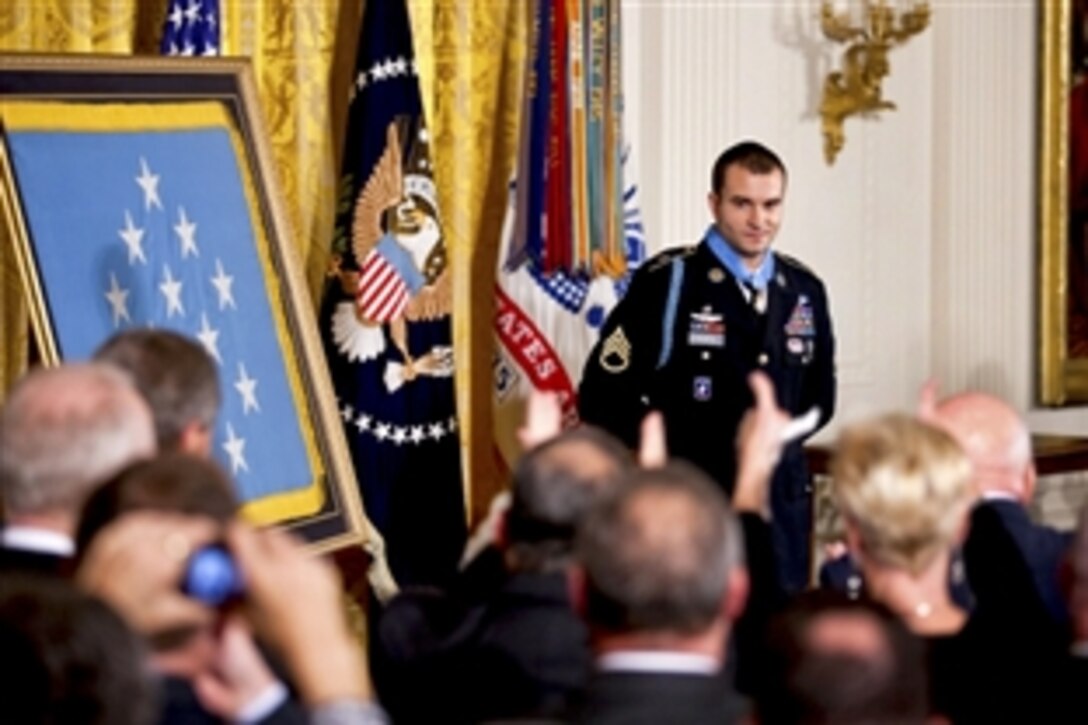 U.S. Army Staff Sgt. Salvatore Giunta stands before an applauding audience after receiving the Medal of Honor from President Barack Obama during a ceremony at the White House, Nov. 16, 2010. Giunta is the award's first living recipient since the Vietnam War.