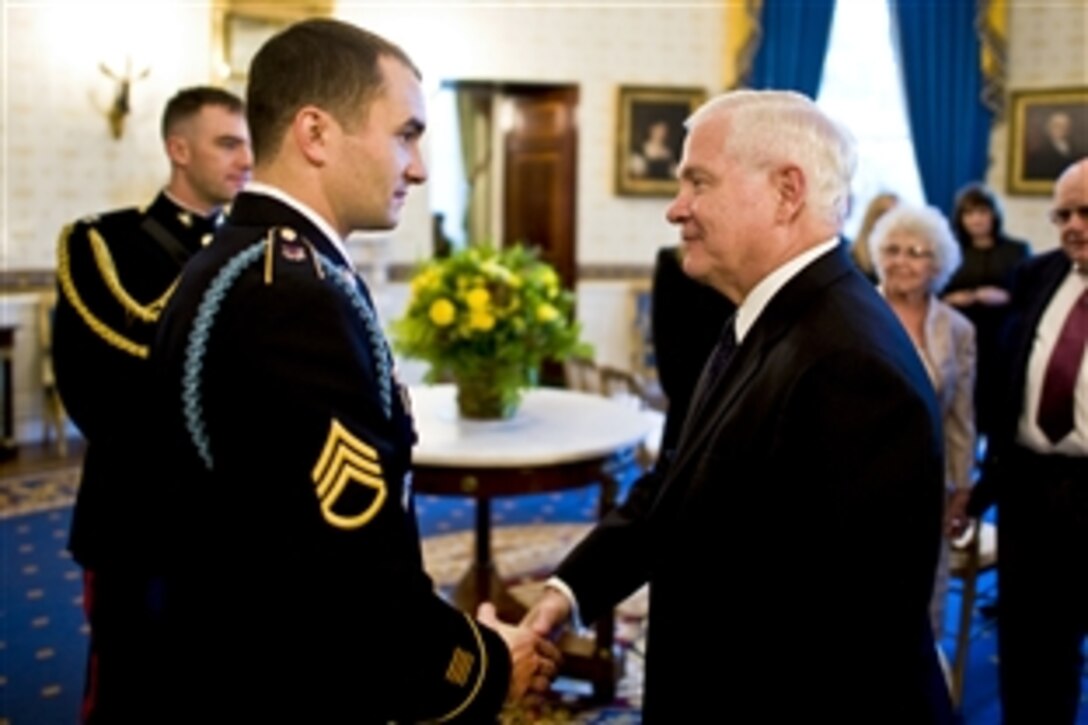 U.S. Army Staff Sgt. Salvatore Giunta talks to Defense Secretary Robert M. Gates before Giunta's Medal of Honor ceremony at the White House, Nov. 16, 2010. Giunta is the first living veteran from the wars in Iraq and Afghanistan to receive the award. 