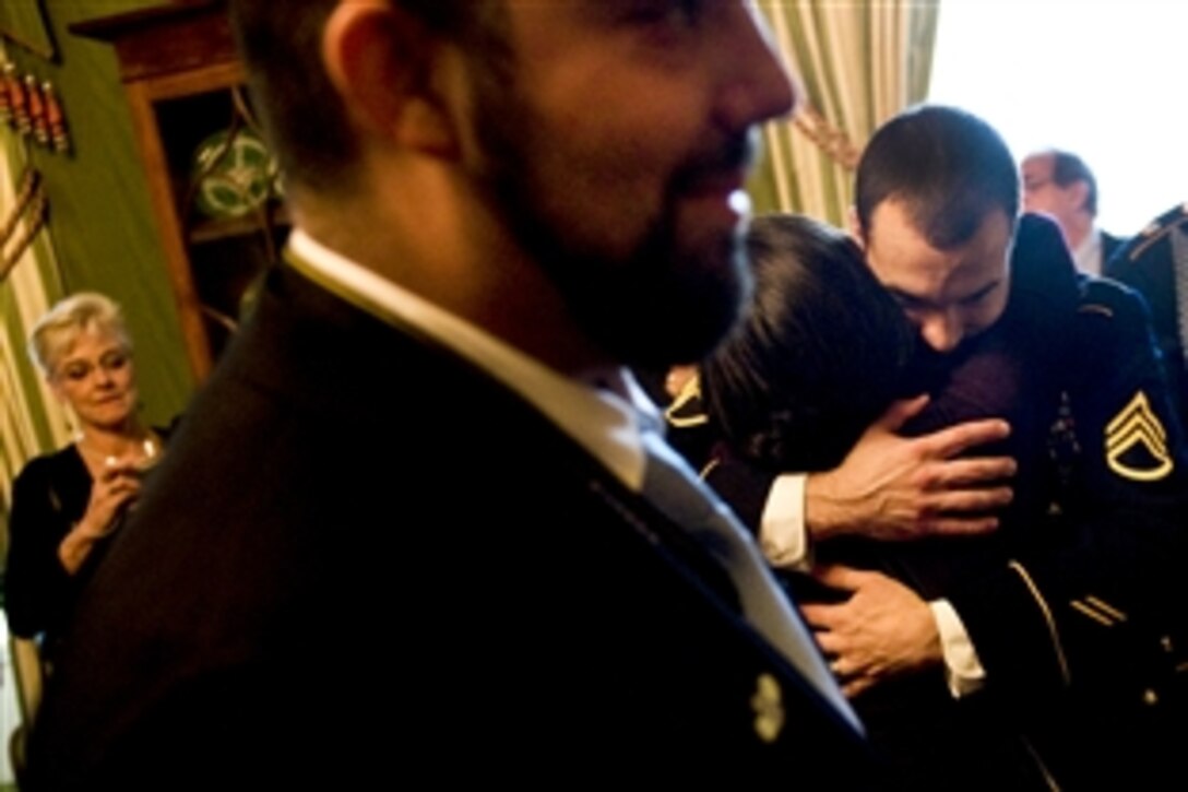 Army Staff Sgt. Salvatore Giunta embraces a friend at the conclusion of his Medal of Honor ceremony at the White House in Washington, D.C., Nov. 16, 2010.