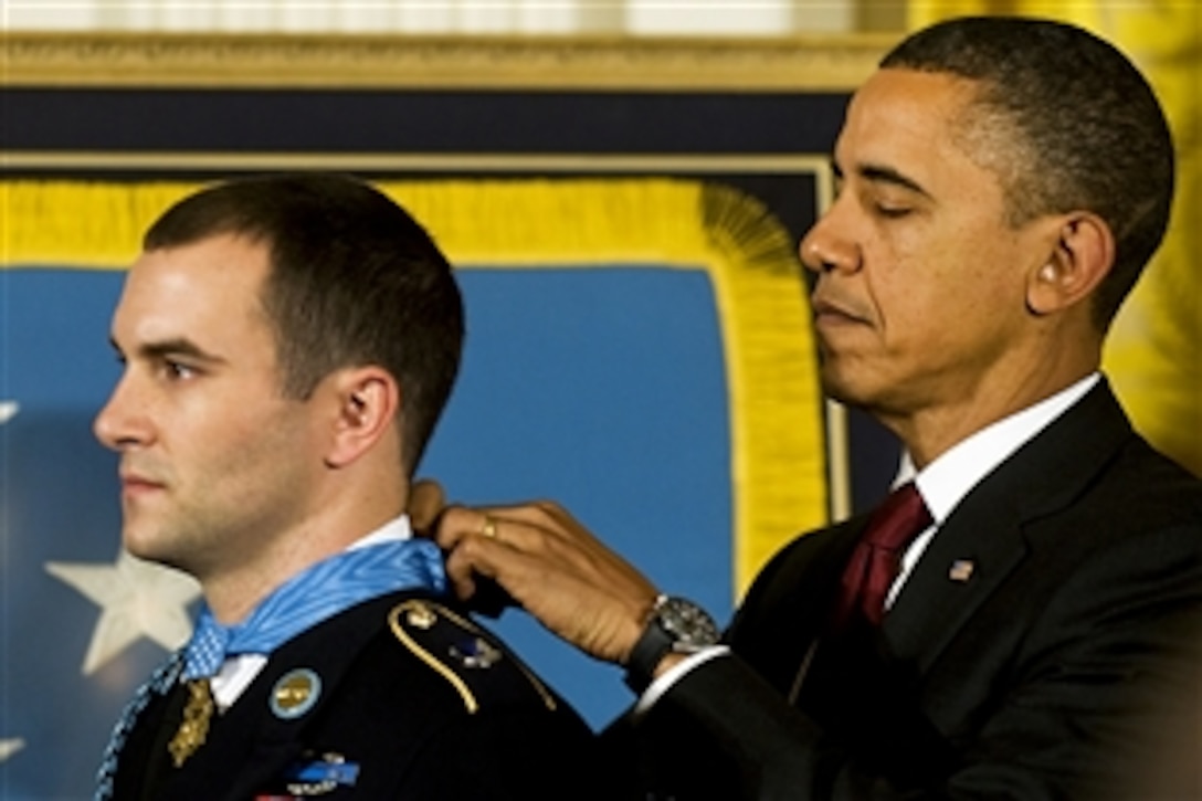 President Barack Obama presents the Medal of Honor to Staff Sgt. Salvatore Giunta, who rescued two members of his squad in October 2007 while fighting in the war in Afghanistan, at the White House in Washington D.C., Nov. 16, 2010.