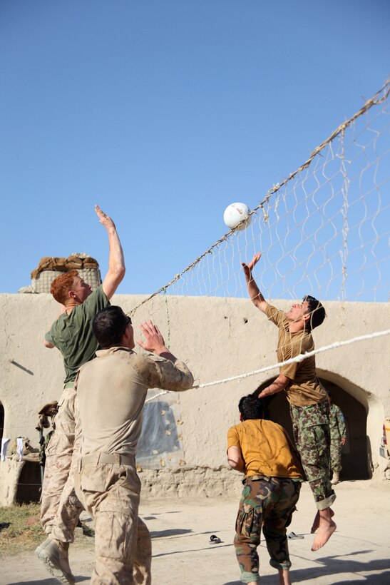 Sergeant Matthew Owen, a squad leader with India Company, 3rd Battalion, 5th Marine Regiment, jumps to block the spike of an Afghan National Army soldier during a friendly volleyball game at ANA Post Nabi Nov. 16, 2010. The game started after the local ANA commander said his soldiers love volleyball and the Marines offered to play with them.