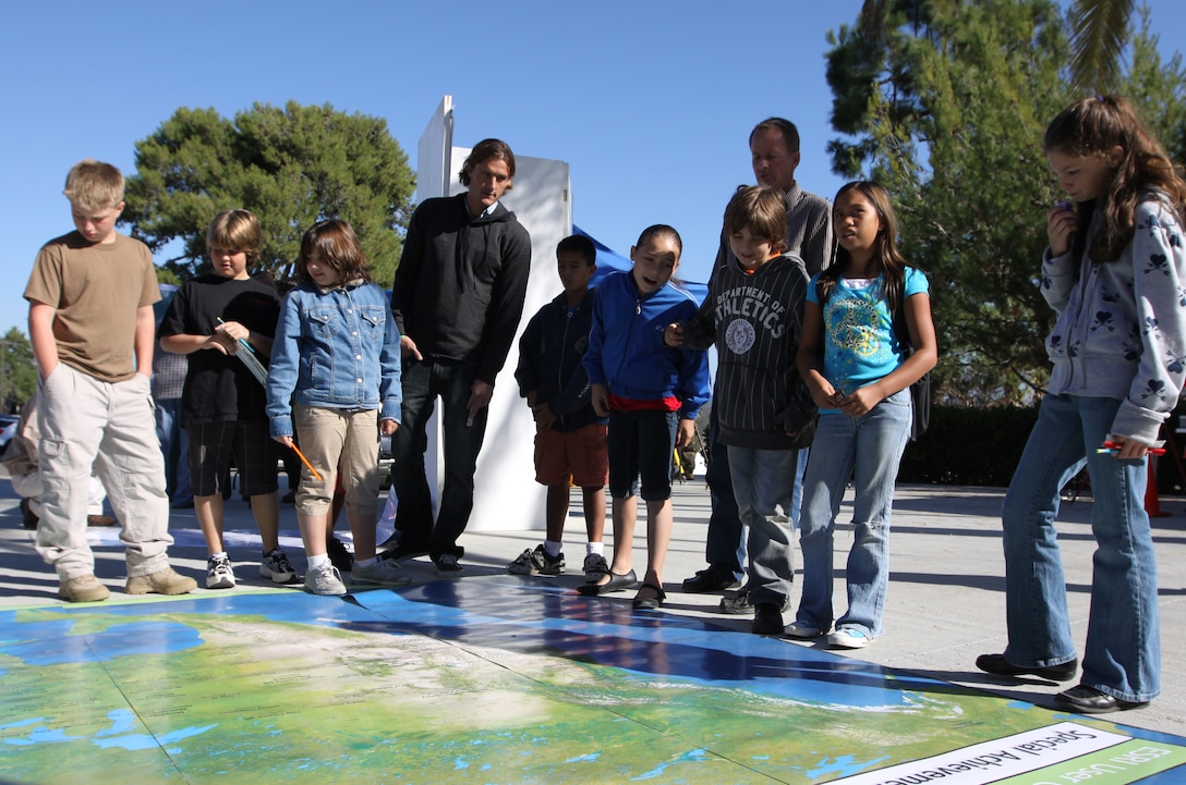 Children from Mary Fay Camp Pendleton Elementary School examine a map during the fourth annual Geospatial Information Systems Day, Nov. 17, at building 1160. More than 100 students from the base’s school attended the event for a better understanding of what GIS is, through visual displays, informational booths and by receiving first-hand information from the base’s GIS experts.