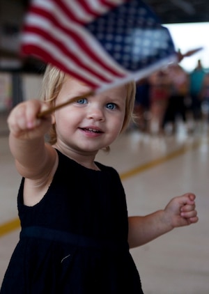 The 21-month-old daughter of Lt. Cmdr. Alan Miller, training officer, Patrol Squadron 9, waves an American flag and greets her father as he returns to Marine Corps Air Station Kaneohe Bay, Hawaii, from a six-month deployment, Nov. 16, 2010. During the deployment, VP-9 detached throughout the Navy’s 5th and 7th Fleet areas of responsibility. A group of VP-9 P-3s supported 5th Fleet maritime operations in Operation Iraqi Freedom from Isa Air Base in Bahrain. From their hub at Kadena Air Base, the remaining portion of VP-9 detached throughout the 7th Fleet AOR, working with a variety of coalition partners including Guam, Indonesia, Malaysia, the Philippines, Singapore, South Korea and Thailand.