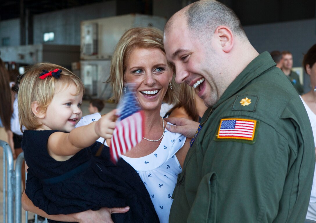 Lt. Cmdr. Alan Miller, training officer, Patrol Squadron 9, receives a warm welcome from his wife and daughter after returning to Marine Corps Air Station Kaneohe Bay, Hawaii, from a six-month deployment, Nov. 16, 2010. During the deployment, VP-9 detached throughout the Navy’s 5th and 7th Fleet areas of responsibility. A group of VP-9 P-3s supported 5th Fleet maritime operations in Operation Iraqi Freedom from Isa Air Base in Bahrain. From their hub at Kadena Air Base, the remaining portion of VP-9 detached throughout the 7th Fleet AOR, working with a variety of coalition partners including Guam, Indonesia, Malaysia, the Philippines, Singapore, South Korea and Thailand.