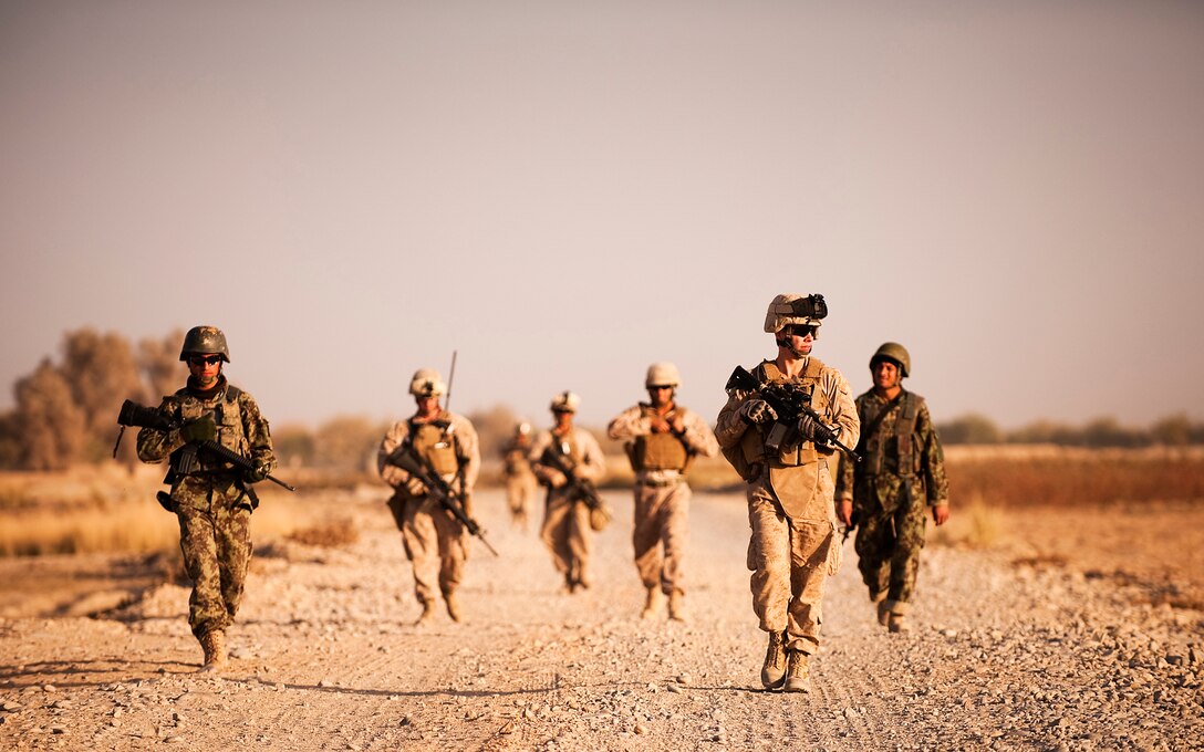 Cpl. Christopher Squire, a squad leader with Headquarters Company, 3rd Battalion, 3rd Marine Regiment, and his squad return to Forward Operating Base Geronimo after providing security in Nawa, Afghanistan Nov. 17, 2010. Squire and his squad provided security while Afghan National Army Soldiers and U.S. Army personnel gave out supplies as a goodwill gesture during the Muslim holiday of Id al-Adha, the Feast of Sacrifice. Squire is from Grayling, Mich.