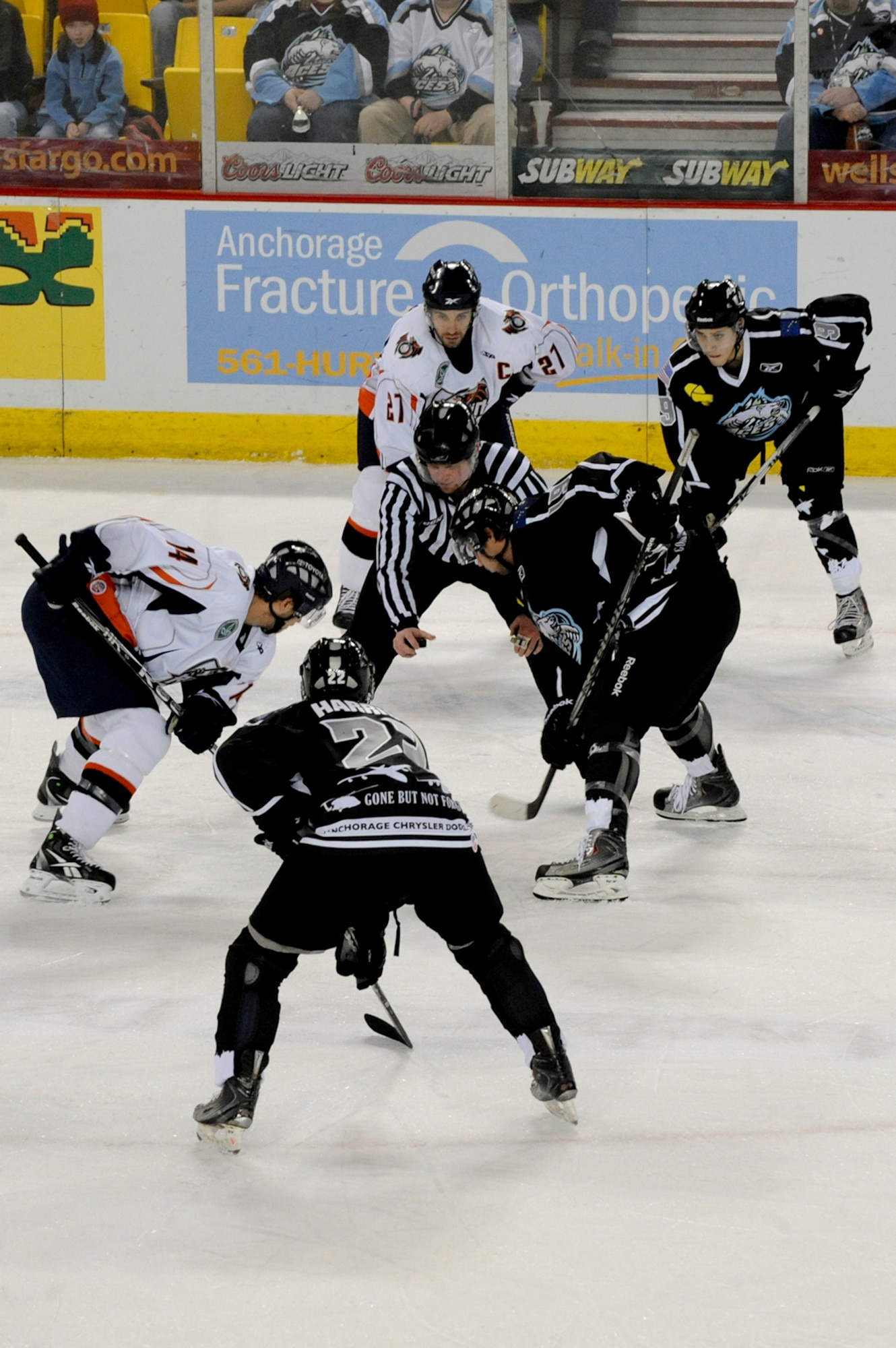 ANCHORAGE, Alaska --  Members of the Ontario Reign and the Alaska Aces prepare to face off for control of the puck during the military appreciation day game here, Nov. 12. The Aces annually host a weekend of games that are in honor of the Armed Forces serving in Alaska.(U.S. Air Force photo by Staff Sgt. Joshua Garcia)