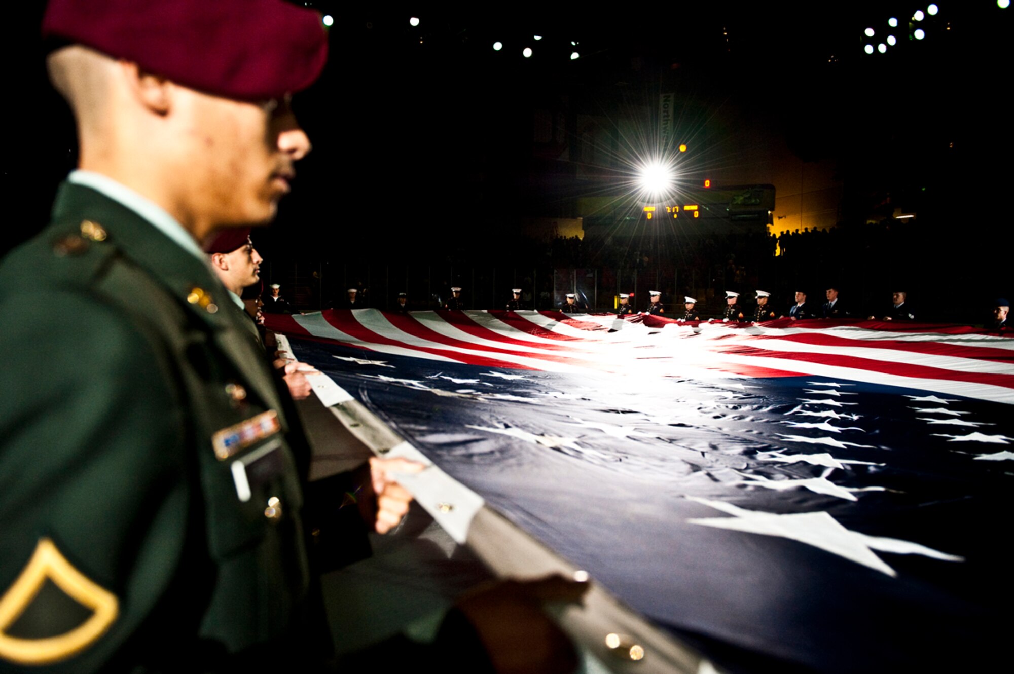 JOINT BASE ELMENDORF-RICHARDSON, Alaska -- Military members present the American Flag during the singing of the National Anthem before the first Alaska Aces military appreciation game against Ontario Reign, Nov.12. (Air Force photo by Airman 1st Class Jack Sanders)