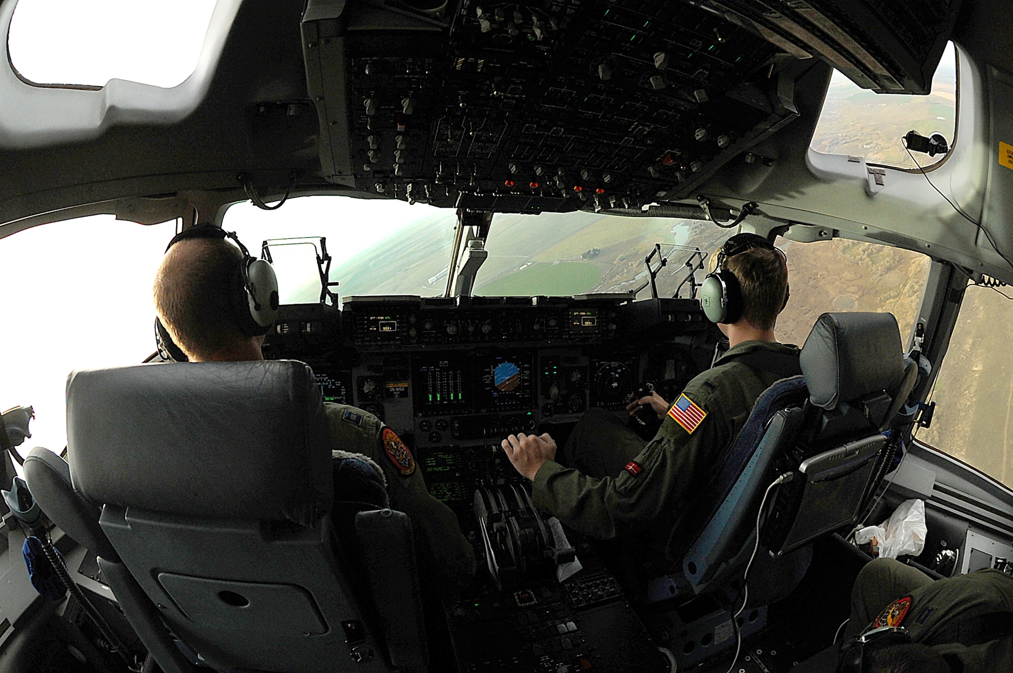 Members of a 535th Airlift Squadron C-17 Globemaster III aircrew participate in a flight above the Pacific Northwest as part of a training mission Nov. 13, 2010, at Joint Base Lewis-McChord, Wash. The aircrew trained in unrestricted-descent assault landings, airdrop, combat offloads, air refueling, night-vision-goggle training, low levels, mountainous terrain, assault landings, threat responses and multiple-ship formation training. (U.S. Air Force photo/Staff Sgt. Mike Meares)