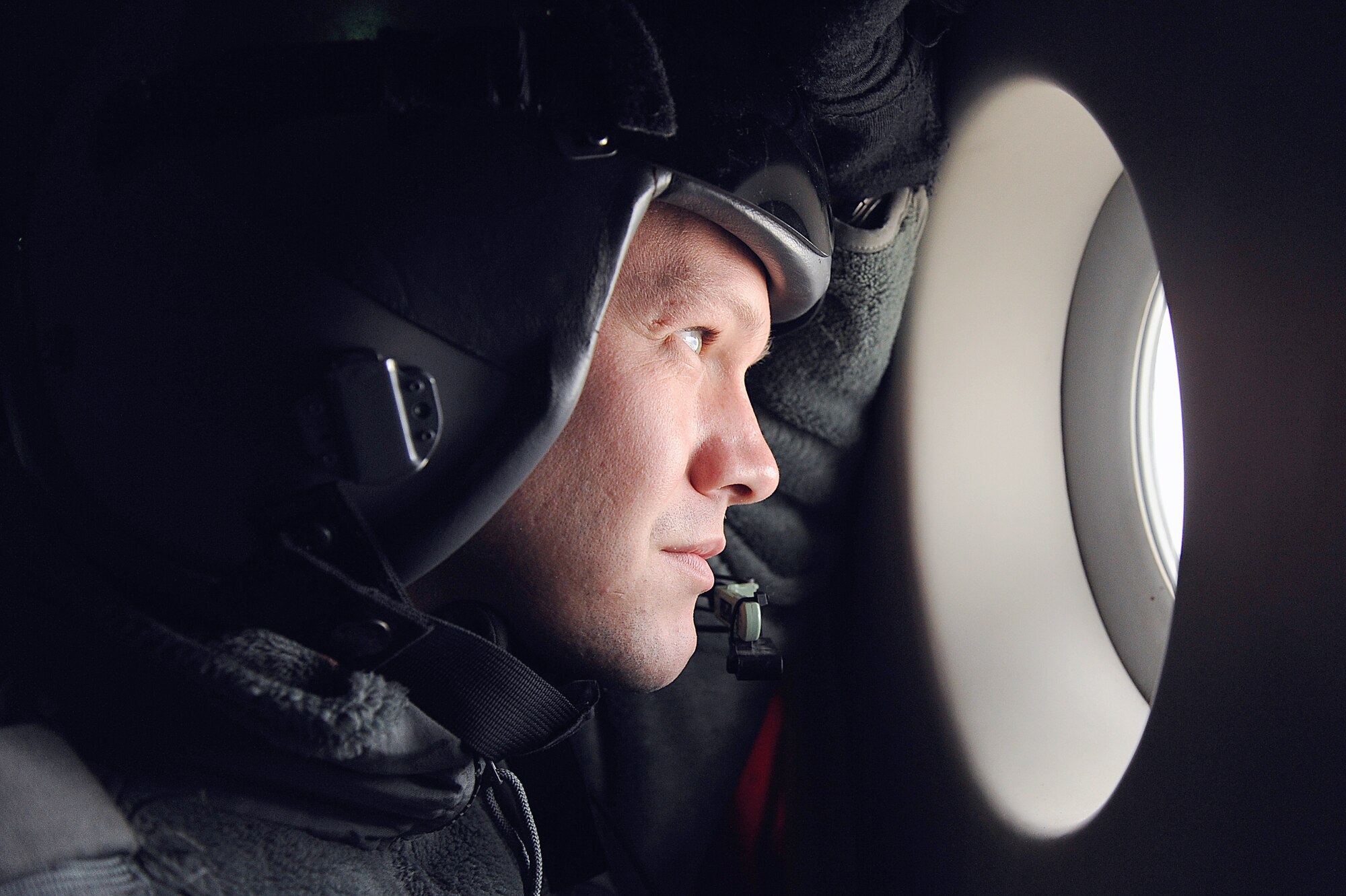 Staff Sgt. Jason Jones looks out over the mountainous terrain of the Pacific Northwest during a training mission Nov. 13, 2010, at Joint Base Lewis-McChord, Wash. A C-17 Globemaster III aircrew from the 535th Airlift Squadron trained in unrestricted-descent assault landings, airdrop, combat offloads, air refueling, night-vision-goggle training, low levels, mountainous terrain, assault landings, threat responses and multiple-ship formation training. Sergeant Jones is a 535th AS loadmaster. (U.S. Air Force photo/Staff Sgt. Mike Meares)