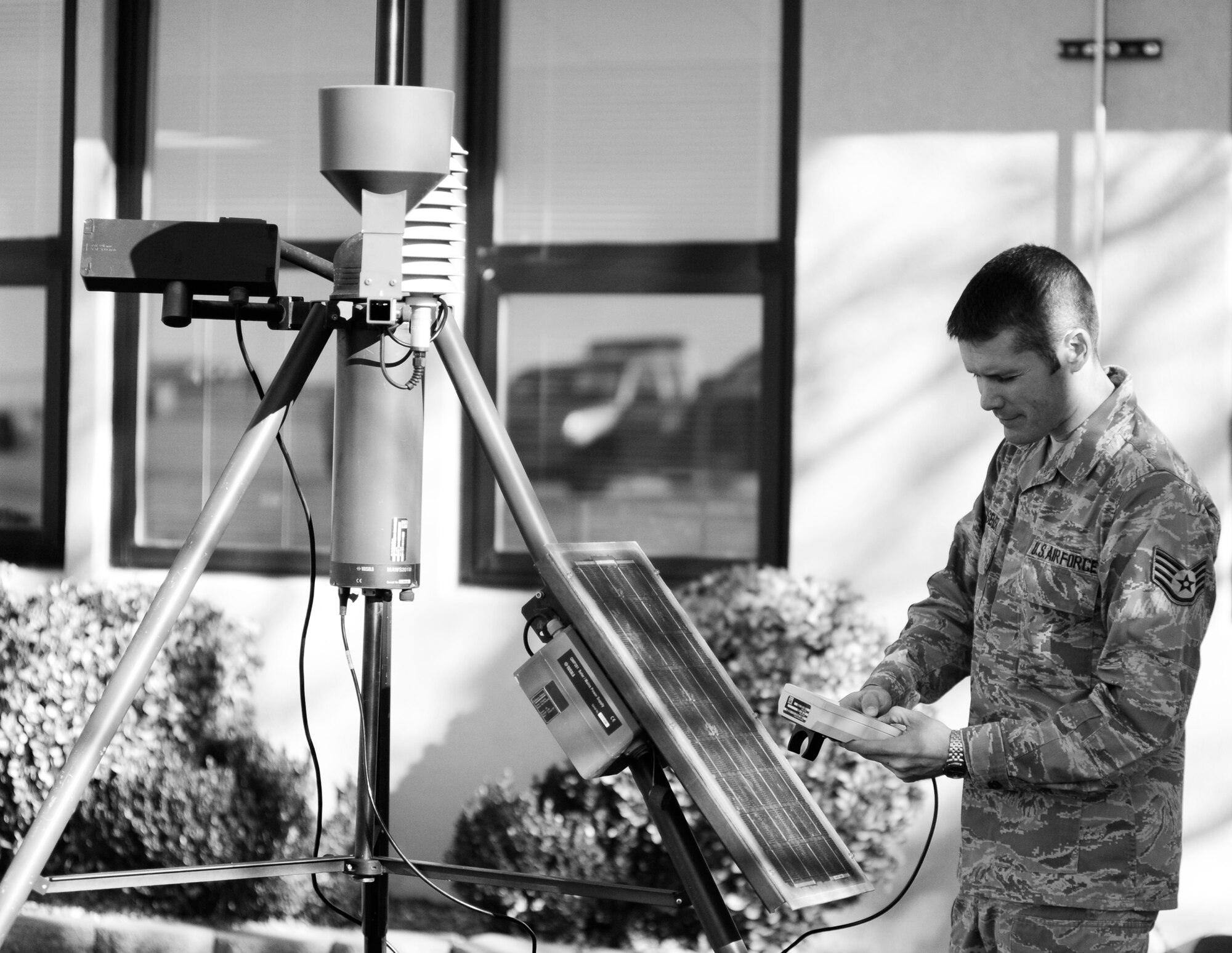 Staff Sgt. James Klusener, 22nd Operations Support Squadron weather forecaster, monitors a meteorological observing system, TMQ-53, Nov. 16, 2010, McConnell Air Force Base Kan. The Topeka, Kan., native measures pressure, wind speed and direction, temperature, dew point, relative humidity, precipitation, surface visibility, cloud height and lightning detection using the TMQ-53. After Sergeant Klusener gets the readings, he passes them on to the Team McConnell flying community. (U.S. Air Force photo/Airman 1st Class Armando A. Schwier-Morales)