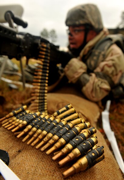 MOODY AIR FORCE BASE, Ga.-- Airman 1st Class Brian Aldred, 23rd Security Forces Squadron defender, lies behind an M-240B machine gun during the Phase II Operational Readiness Exercise security setup Nov. 16. A perimeter was put around the field training site at Base X due to a security breach.  Defenders scanned areas to ensure the site’s safety. (U.S. Air Force Photo/Airman 1st Class Joshua Green)(RELEASED)