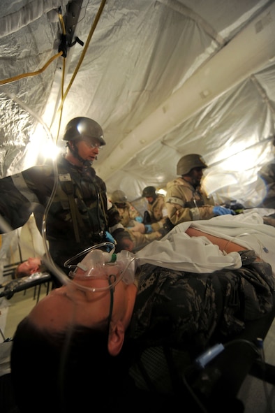 MOODY AIR FORCE BASE, Ga.-- Airmen from the 23rd Medical Group provide medical care to Airman 1st Class Magen Faggart, 71st Rescue Squadron aircrew member, during a Phase II Operational Readiness Exercise Nov. 16. After being wounded and receiving self-aid and buddy care in the field, Airman Faggart received medical attention by the members of the 23rd MDG and was evacuated to a safe location. (U.S. Air Force Photo/Airman 1st Class Joshua Green)(RELEASED)                