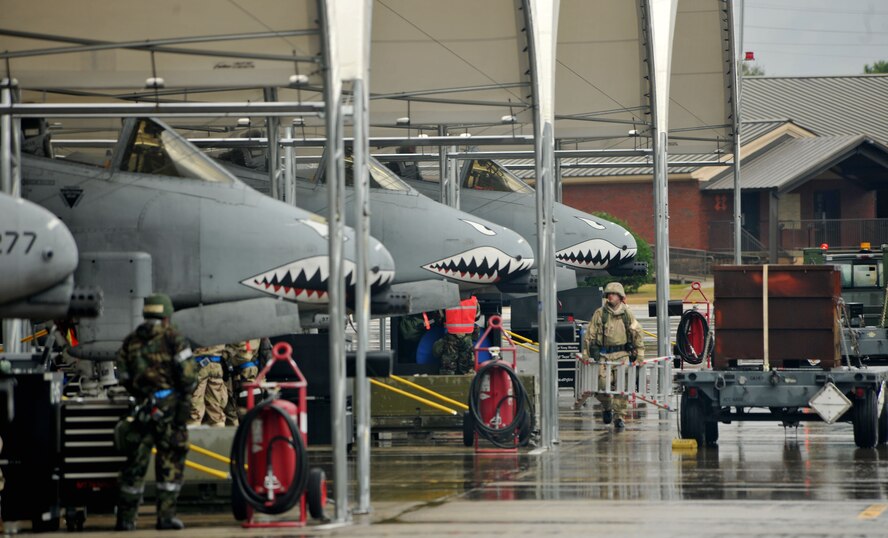 MOODY AIR FORCE BASE, Ga.-- Four A-10C Thunderbolt II aircraft sit under the hangar during a Phase II Operational Readiness Exercise Nov 16. Each aircraft was loaded with munitions and prepped for takeoff to a deployed location for the exercise. (U.S. Air Force Photo/Airman 1st Class Joshua Green)(RELEASED)  