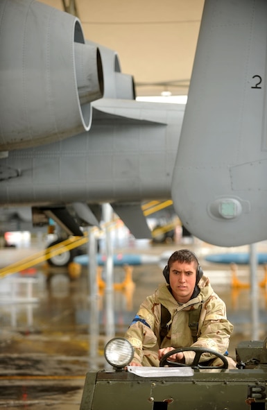 MOODY AIR FORCE BASE, Ga.-- Airman 1st Class Stephen Davarich, 74th Aircraft Maintenance Unit weapons armament systems specialist, waits for a fellow crew member to secure a munition during a Phase II Operational Readiness Exercise Nov 16. After the munition is secured, it will be safely attached to the aircraft. (U.S. Air Force Photo/Airman 1st Class Joshua Green)(RELEASED)