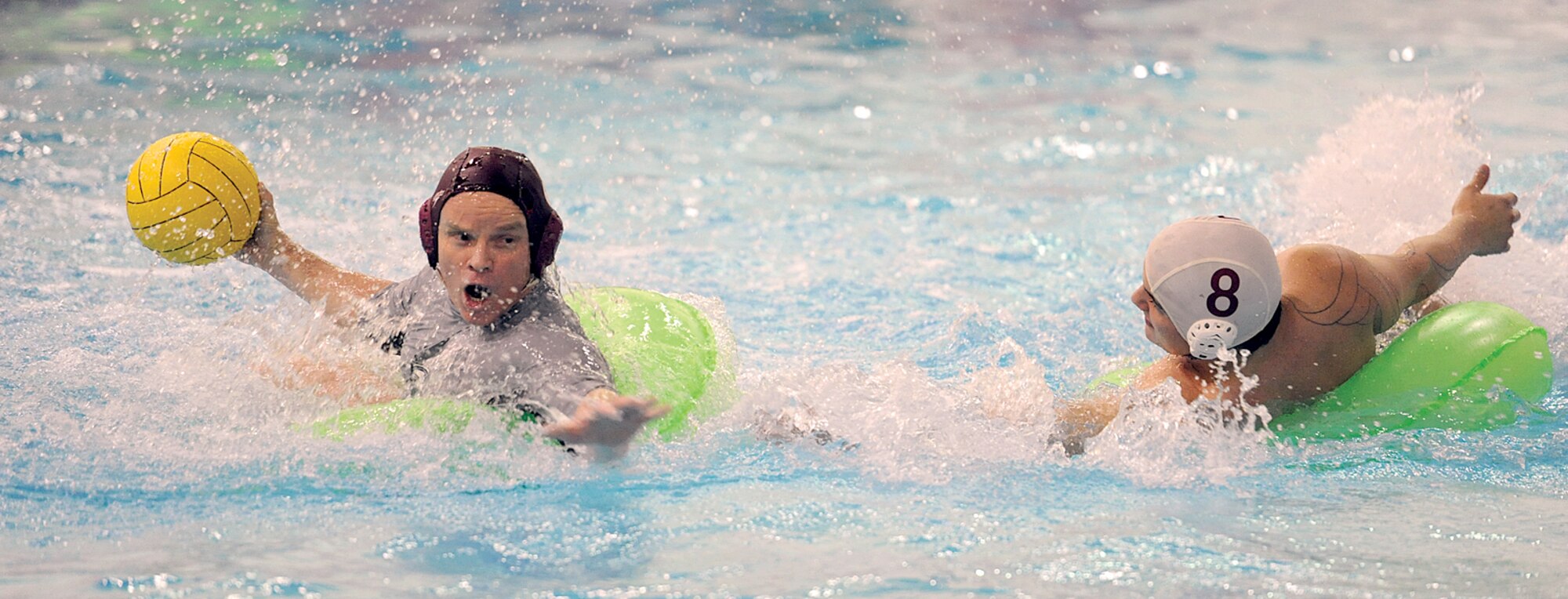 U.S. Army Alaska?s George Fox looks to move the ball past Buckner Physical Fitness Center defender Wrally Dahl in intramural inner tube water polo championship action Nov. 10 at the Buckner pool. The BPFC team beat the undermanned USARAK squad in back-to-back games to claim the water polo title. (Photos by John Pennell/JBER PAO)